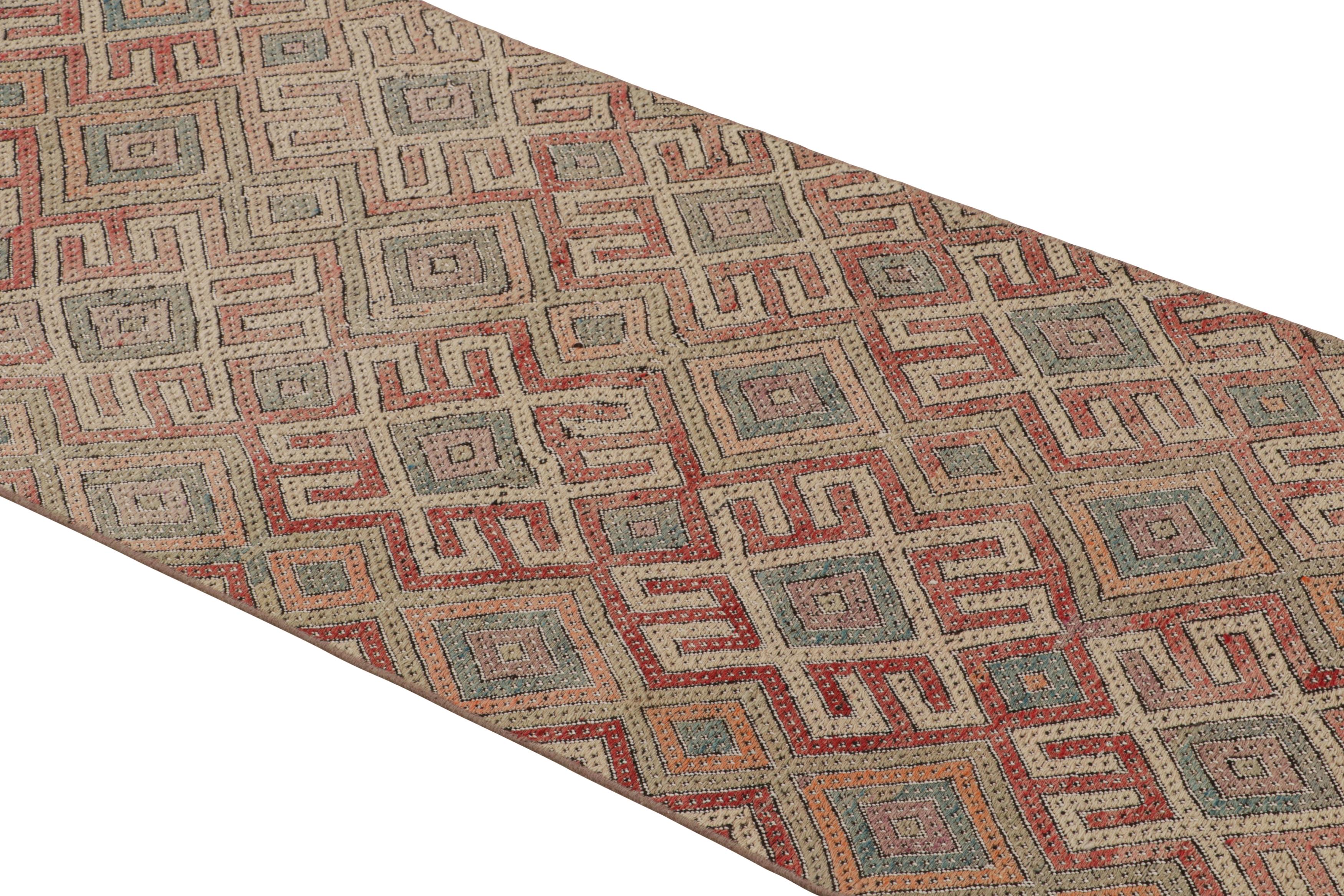 Handwoven in Turkey originating between 1950-1960, this vintage midcentury wool Kilim runner enjoys a meticulous play of embroidery and flat weaving, uncommon and distinguishing of a select line from our recent additions to our collections. The
