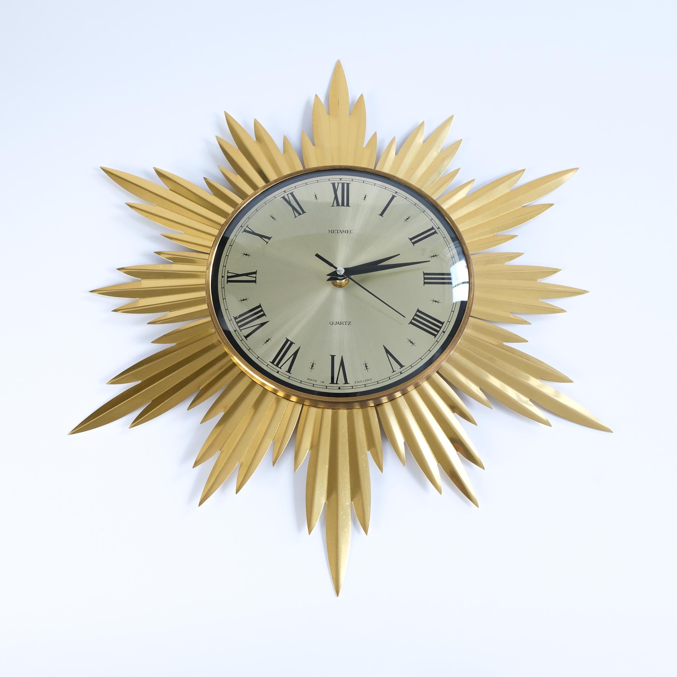 For sale is a Mid-Century Modernist ‘Starburst’ or 'Sunburst' wall clock by Metamec, England and dating from the 1960s.

The clock keeps good time and is in good vintage condition, with wear and patina commensurate with age, which includes some