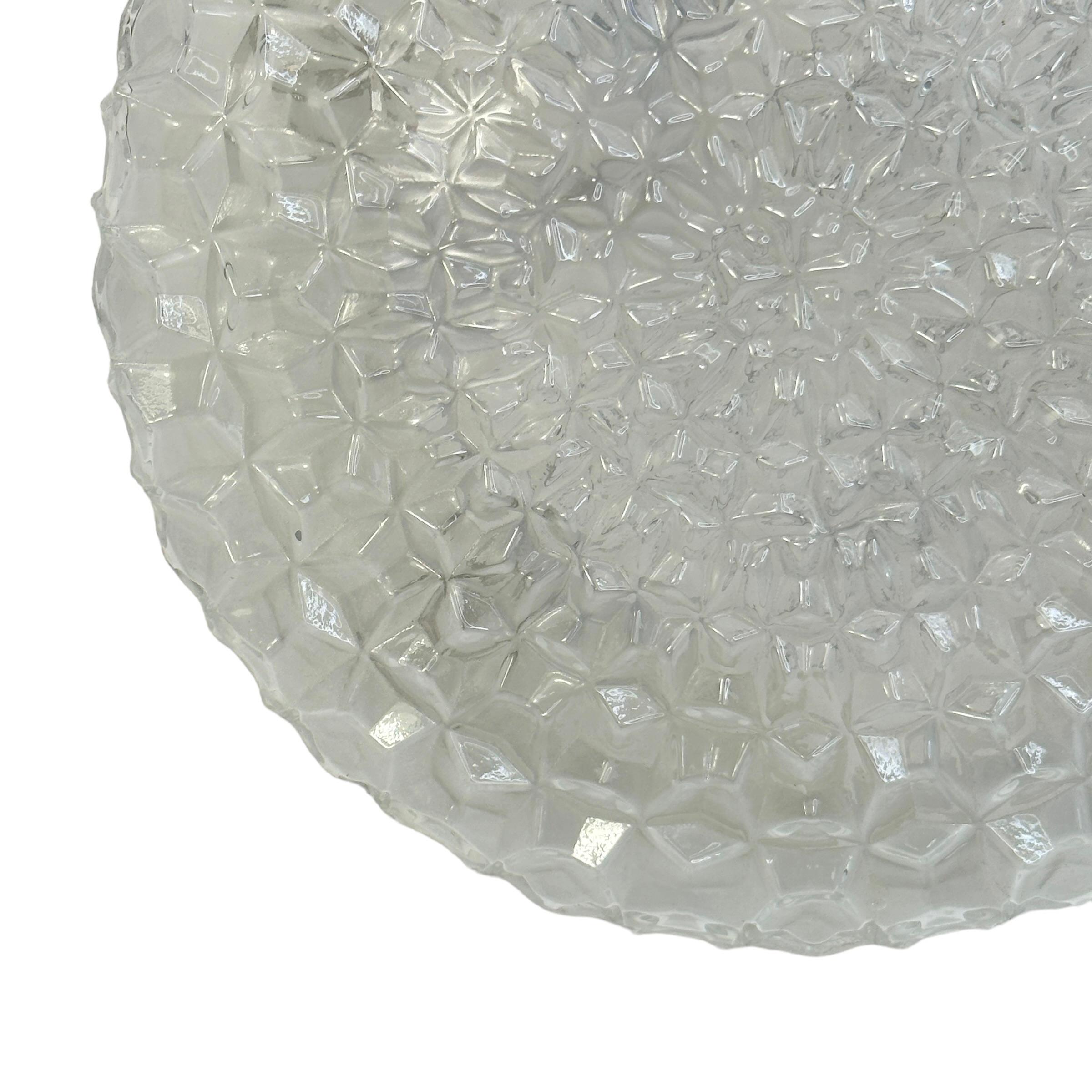 Beautiful ice crystal textured flush mount. Made in Germany by RZB Leuchten. Gorgeous textured glass flush mount with plastic plate. The fixture requires one European E27 Edison bulb up to 75 watts. A nice addition to any room or closet. Found at an