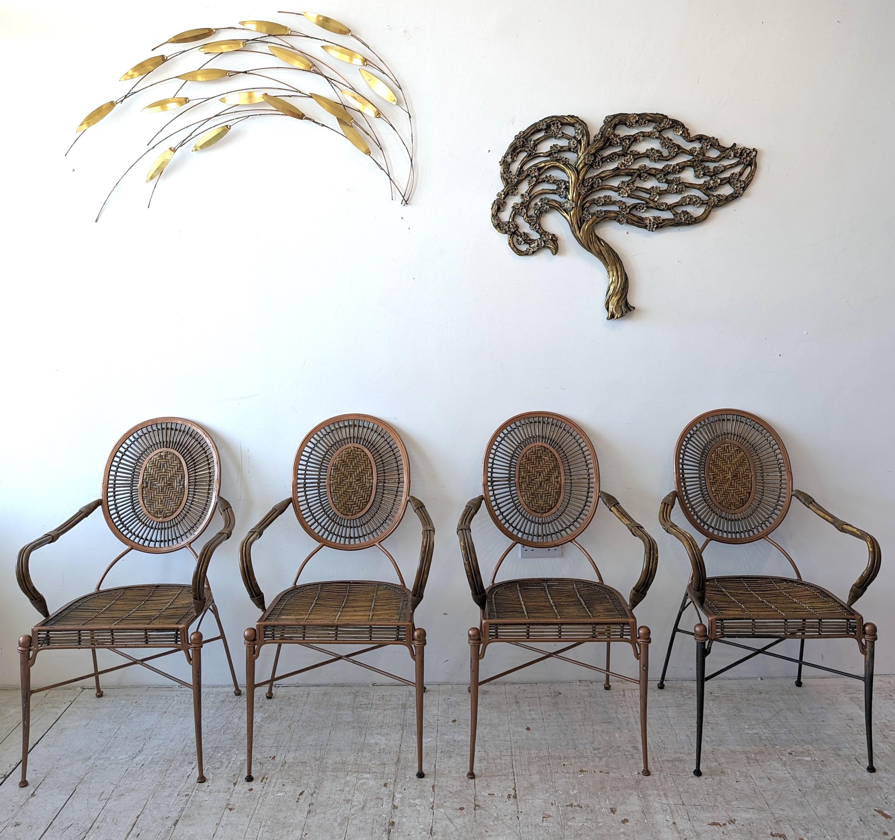 Midcentury iron, cane and rattan armchairs, four available. 
Sourced in the USA, but could originate from Italy? The iron has a gold finish, which is worn in places. One of the chairs has much less gold on the legs ( see photos).The curved bamboo