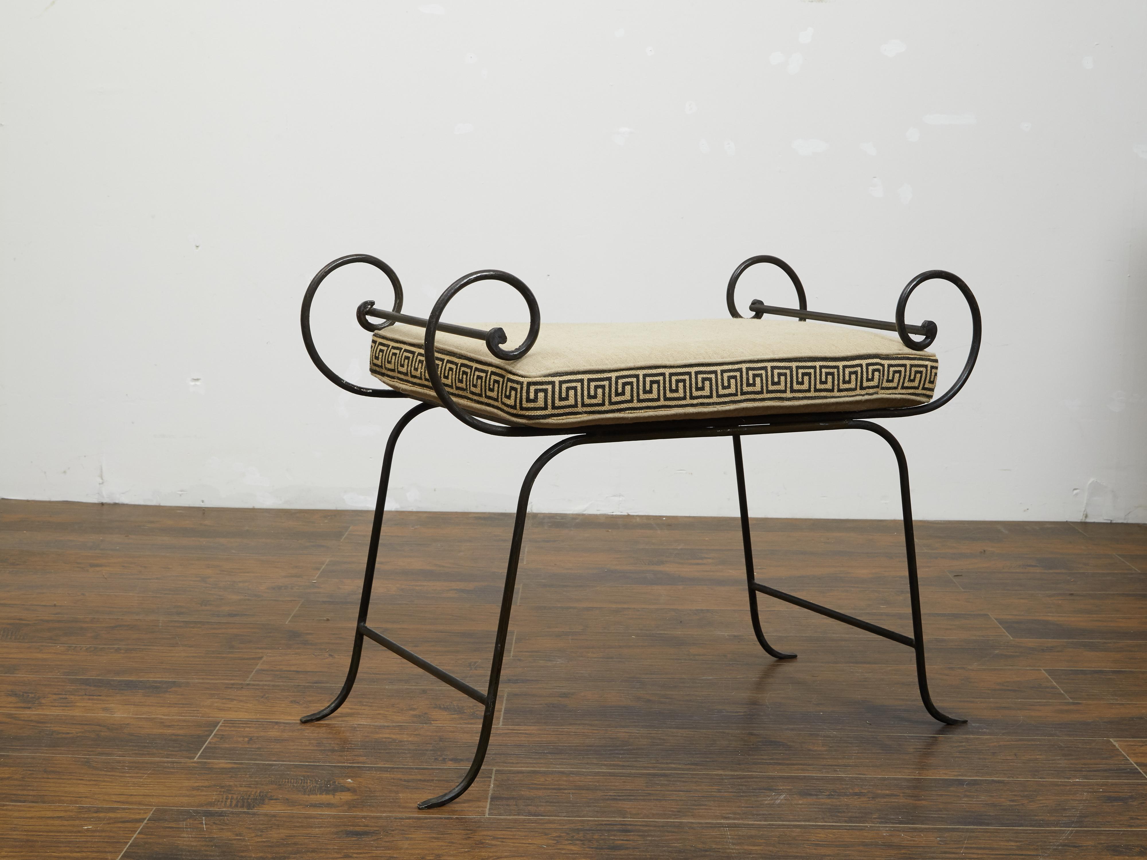 A vintage Italian iron stool from the mid 20th century, with Greek Key embroidered cushion and scrolling accents. We currently have two available, priced and sold $3,750 each. Created in Italy during the midcentury period, this iron stool captures