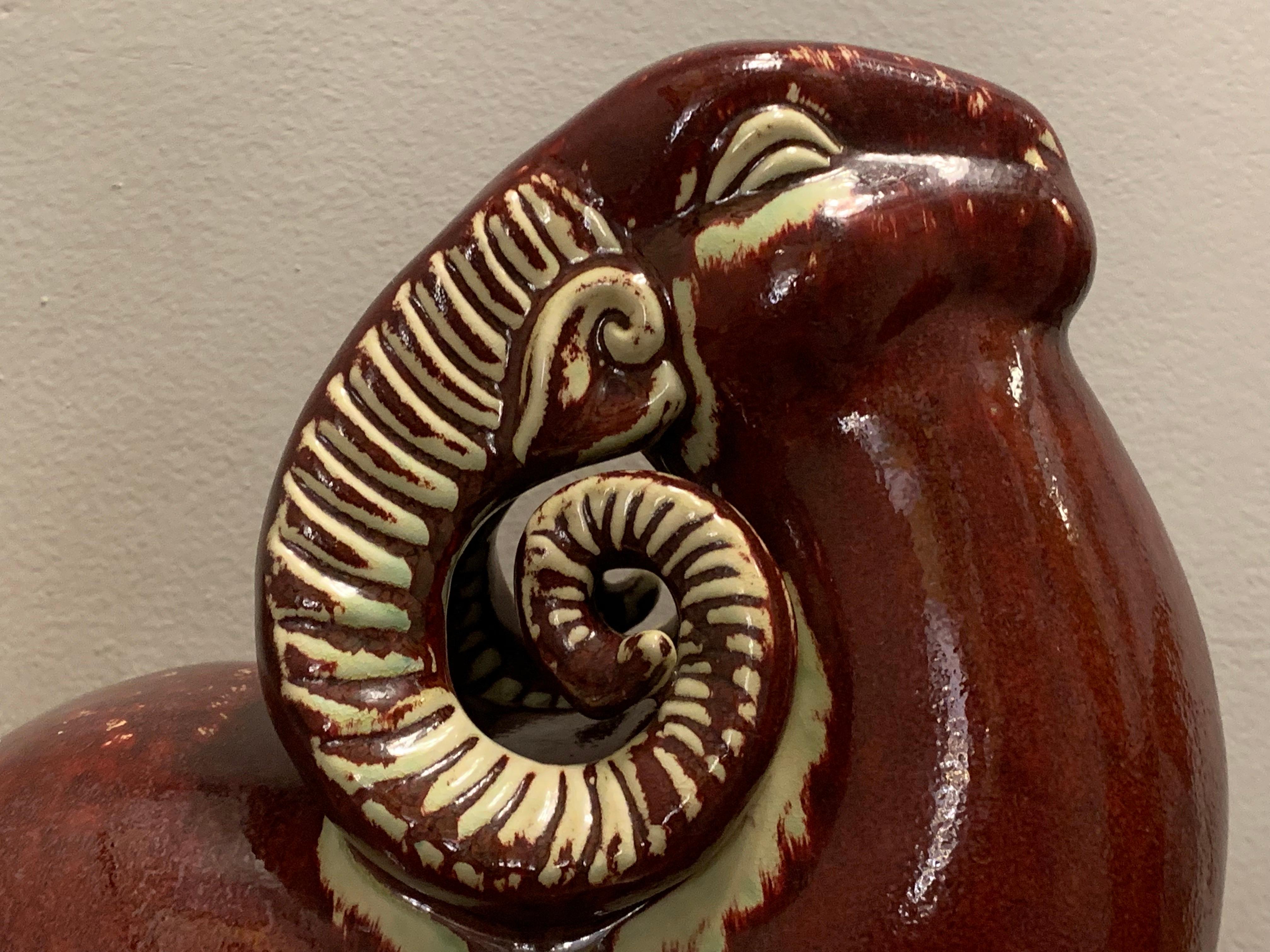 Large vintage Italian ruby red and off-white ceramic decorative glazed ram. The Ram's head is bowed backwards as though it's about to go into battle or is being challenged. The ram's horns are beautifully sculpted and highlighted in white to