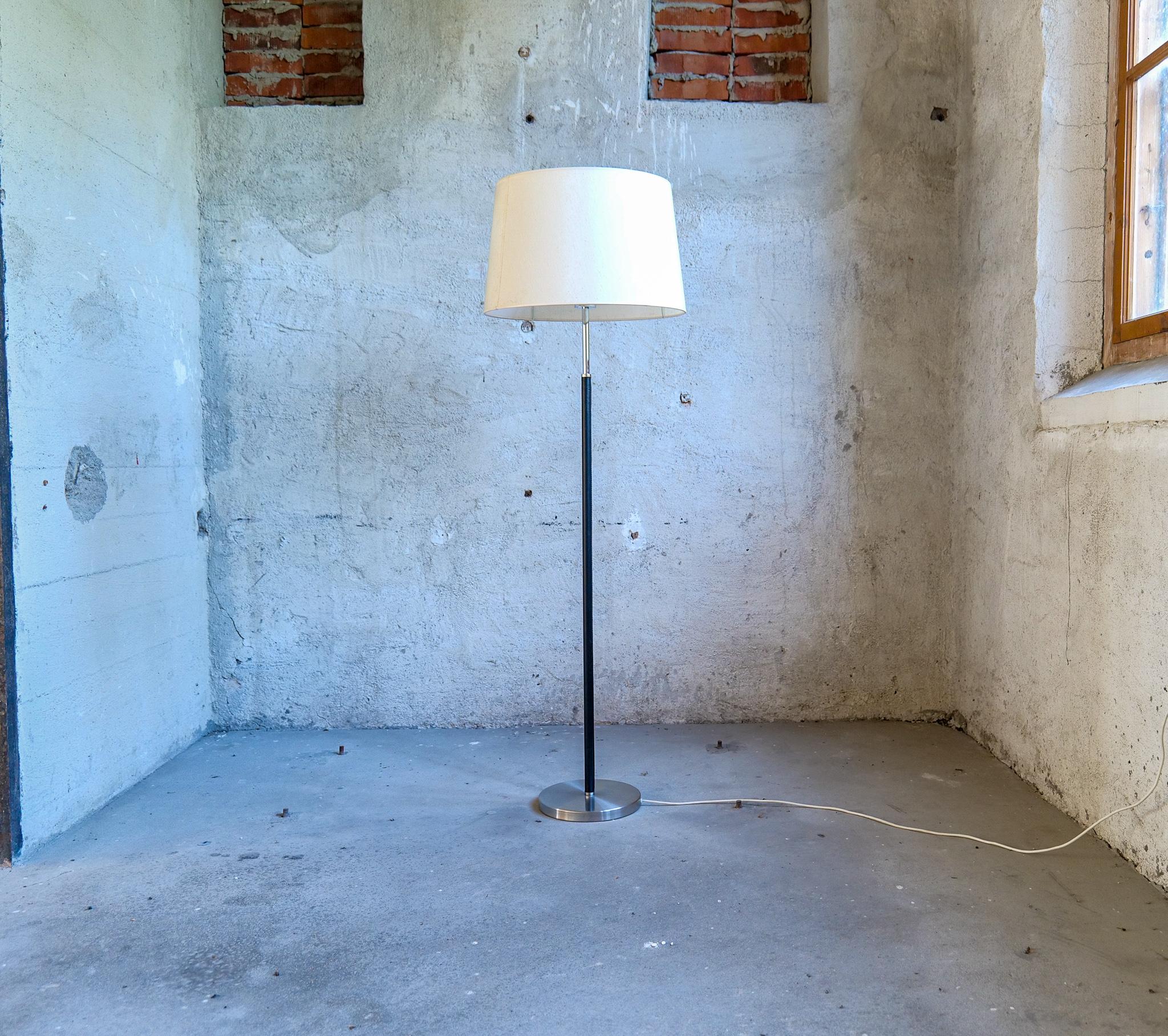 This rare floor lamp is designed by Anders Pehrson who took over the business of Atelje´ Lyktan in 1964. The lamp has a chrome base with a leather rod and chrome on the other parts. Original shades with acrylic plastic on the inside. 

Nice