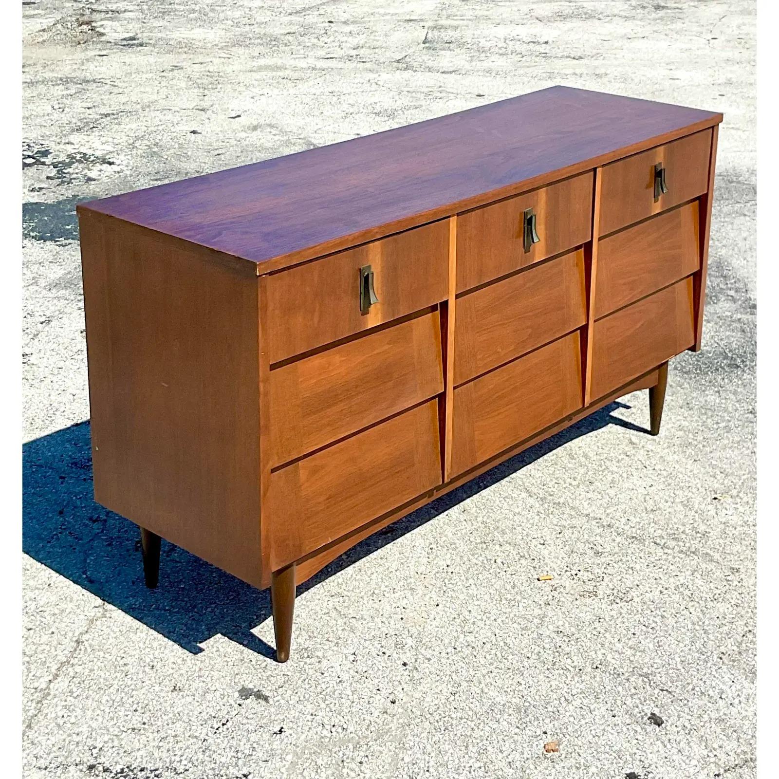 A fantastic vintage MCM 9 drawer dresser. Beautiful two tone wood with a chic Louvered design. Acquired from a Palm Beach estate.