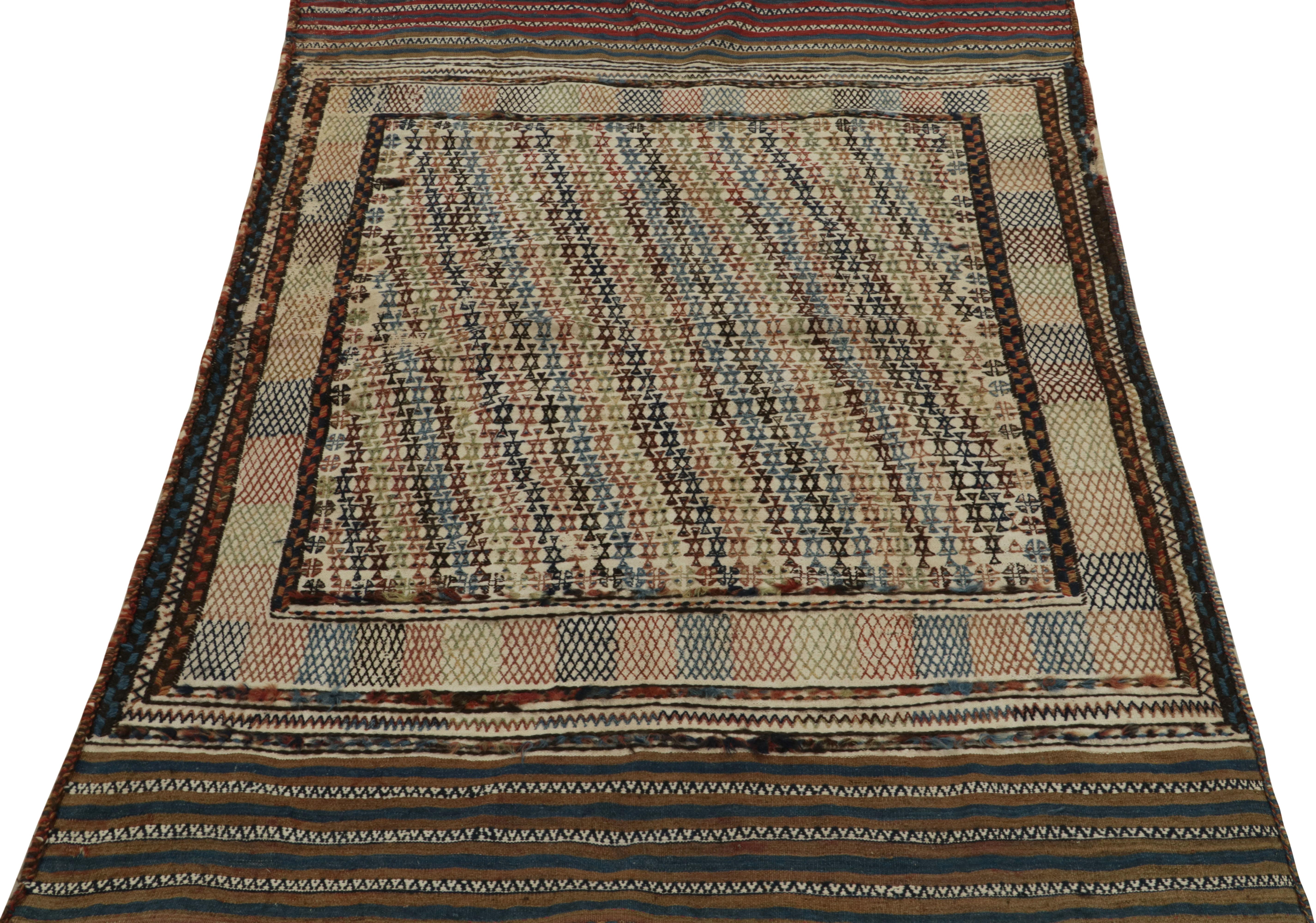Handwoven in wool, a 4x6 Moroccan kilim rug joining our vintage flat weave selections. The rare graph dons a fabulous approach to color with handsome beige-brown, green & blue with white juxtapositions intricately interrupting the tribal pattern for