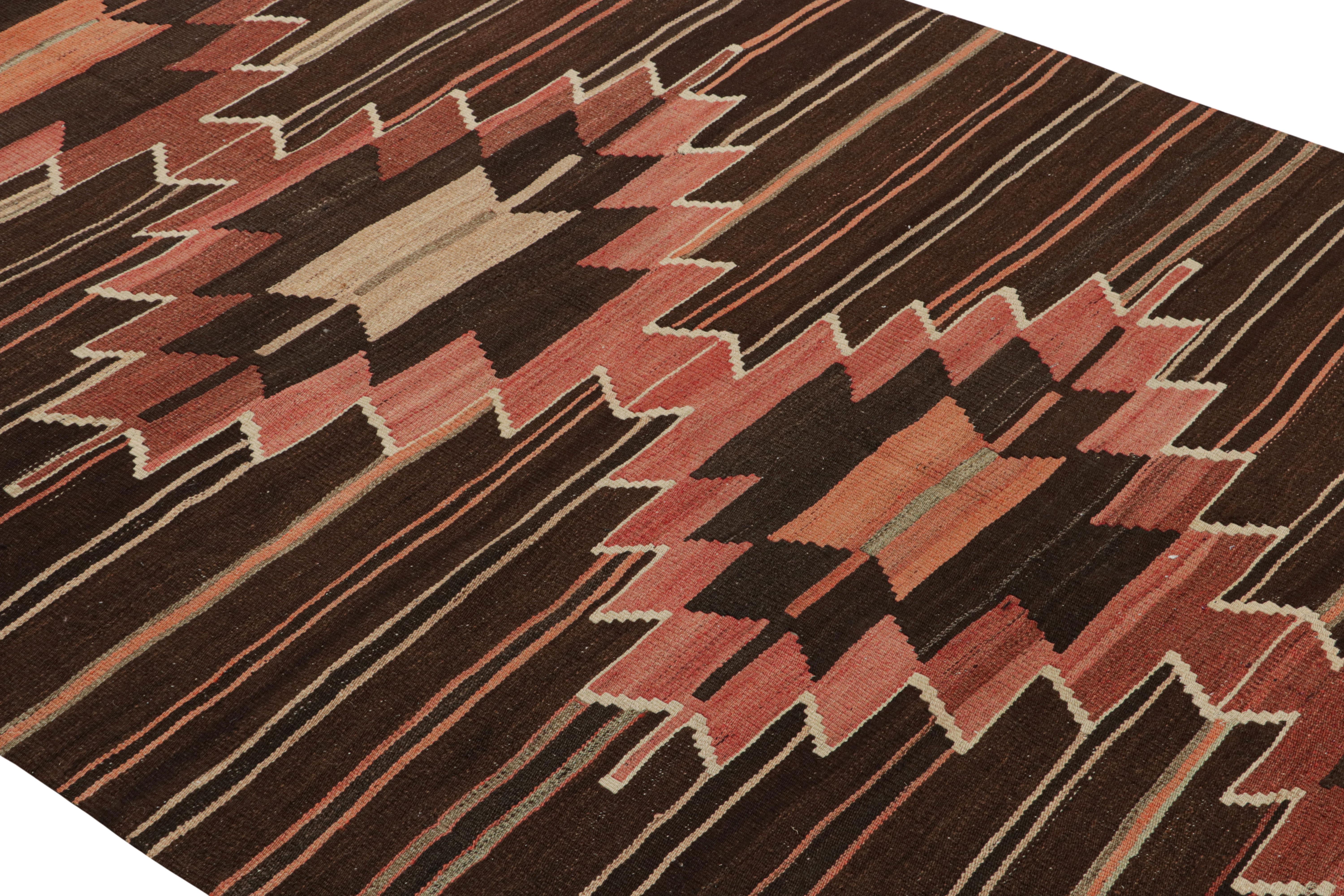 Flat-woven in Turkey originating between 1950-1960, this vintage midcentury tribal Kilim hails from the town of Mut, celebrating the Turkish tradition of marrying sharp geometric dimensionality with a blend of rich and lively hues. The balance of