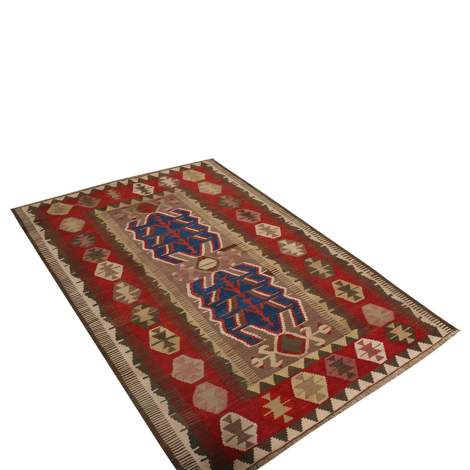 Flat-woven in Turkey originating between 1950-1960, this vintage midcentury wool Kilim hails from the city of Obruk, enjoying rich and warm colorway variations between the beige-brown borders and the bold contrast of red and blue, accented by notes