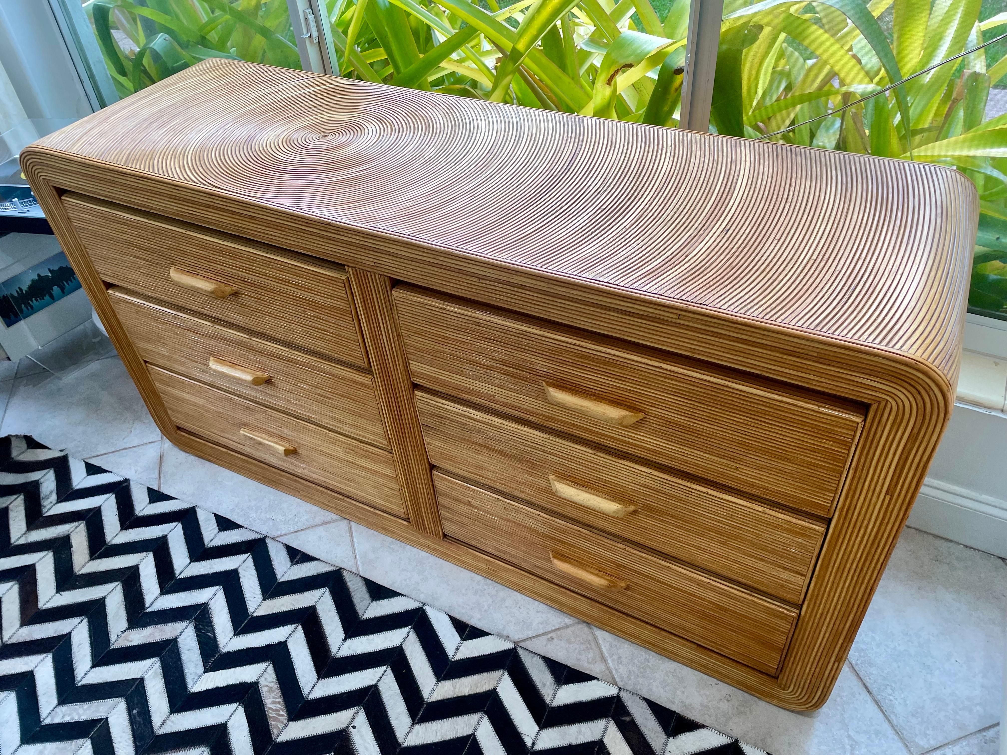 Vintage Midcentury modern pencil reed Rattan Waterfall dresser.Six drawers. Pencil reed rattan labyrinth design showcased throughout with curved sides. Beautiful from all angles. 6 drawers with wooden pulls. 

Height: 30.5 in 
Width: 58 in 
Depth: