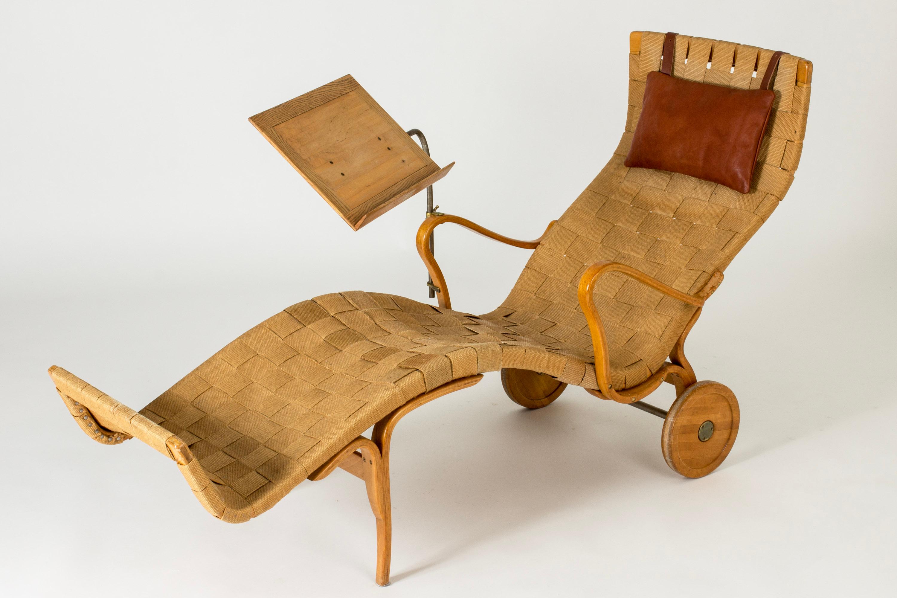 Rare, early edition “Pernilla” chaise lounge with wheels by Bruno Mathsson. Made from solid birch with curved lines. Original wreathed paper webbing, leather neck cushion.