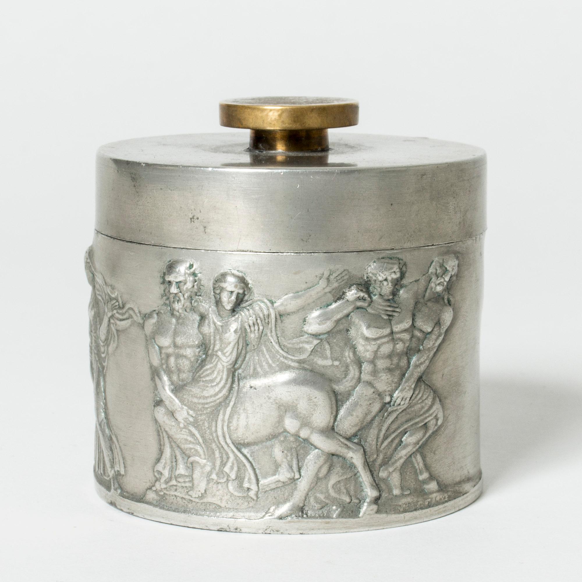 Pewter jar with brass knob. Designed by Herman Bergman, who was the founder of Herman Bergman’s Fine Art Foundry, purveyor to the Royal Court. Beautiful execution.

The images depicted are from the Bassai (sometimes spelled Bassae) Frieze, which was