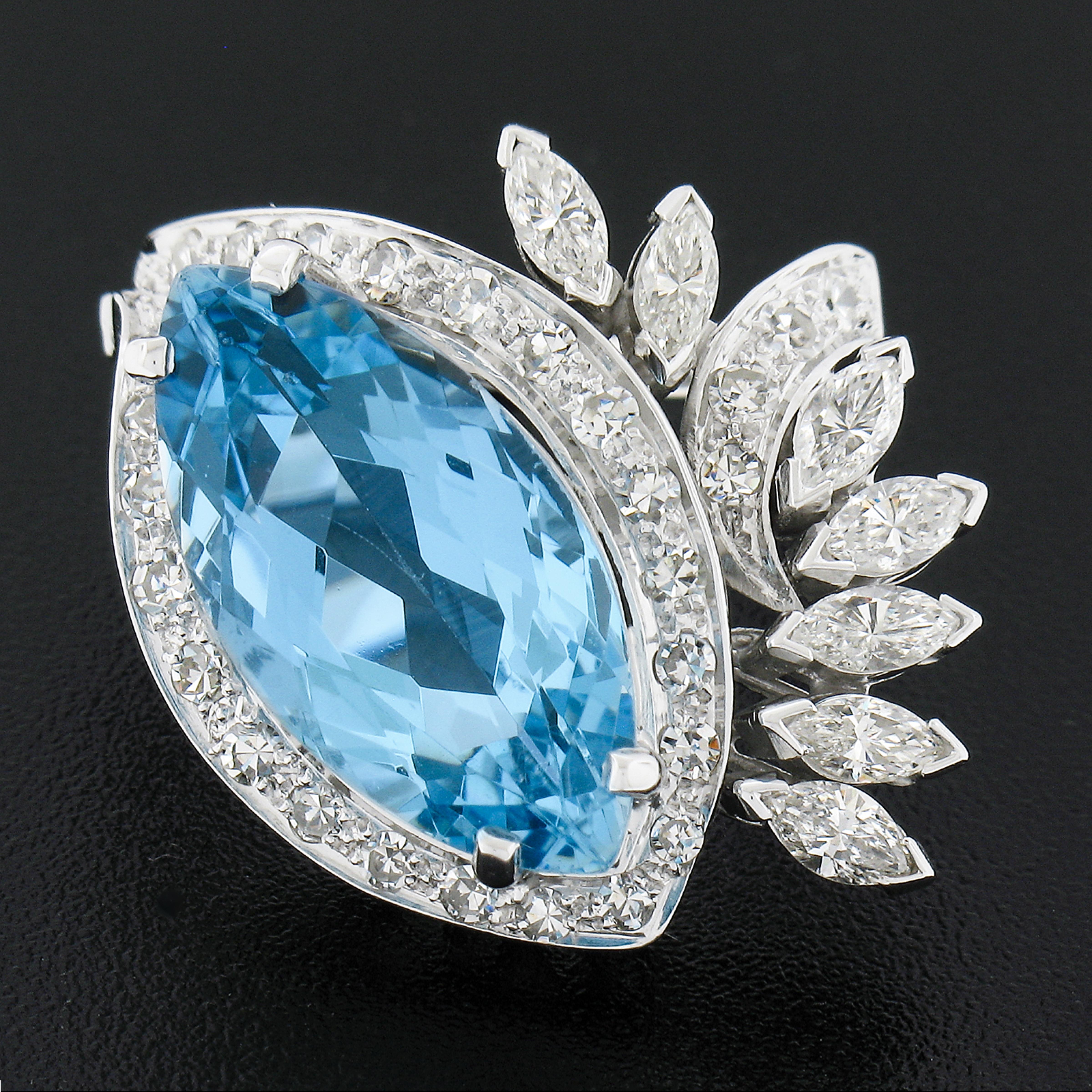 This magnificent and very well made mid-century statement ring is very well crafted in solid platinum and features a large, GIA certified, natural aquamarine solitaire set in a unique design that is drenched with very fine quality diamonds