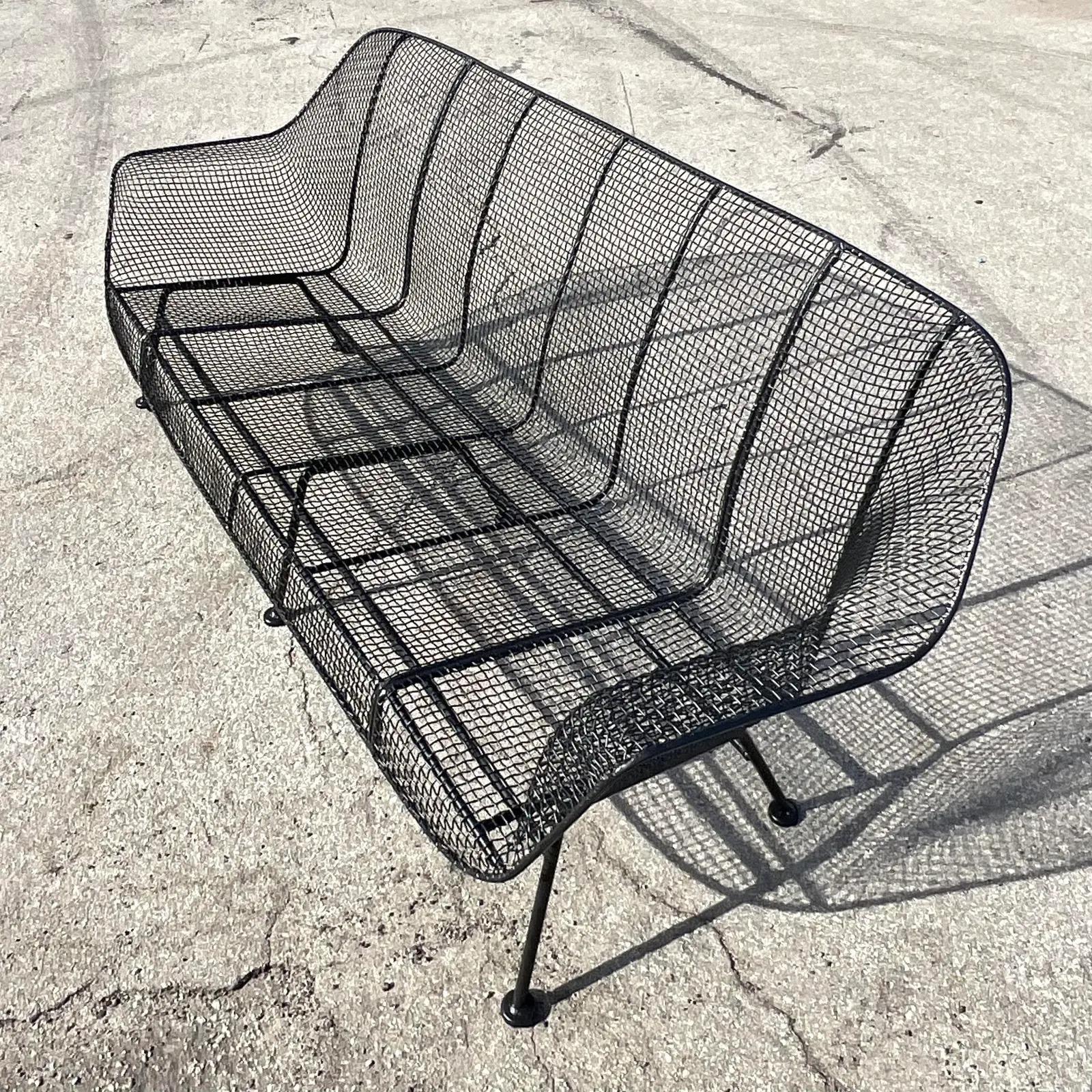 A fantastic vintage Midcentury outdoor sofa. Made by the iconic Russell Woodard. Part of his coveted “Sculptura” collection. The rare extra long design. Fully restored with a fully sand blasted and powder coated finish in a matte black. Unmarked.