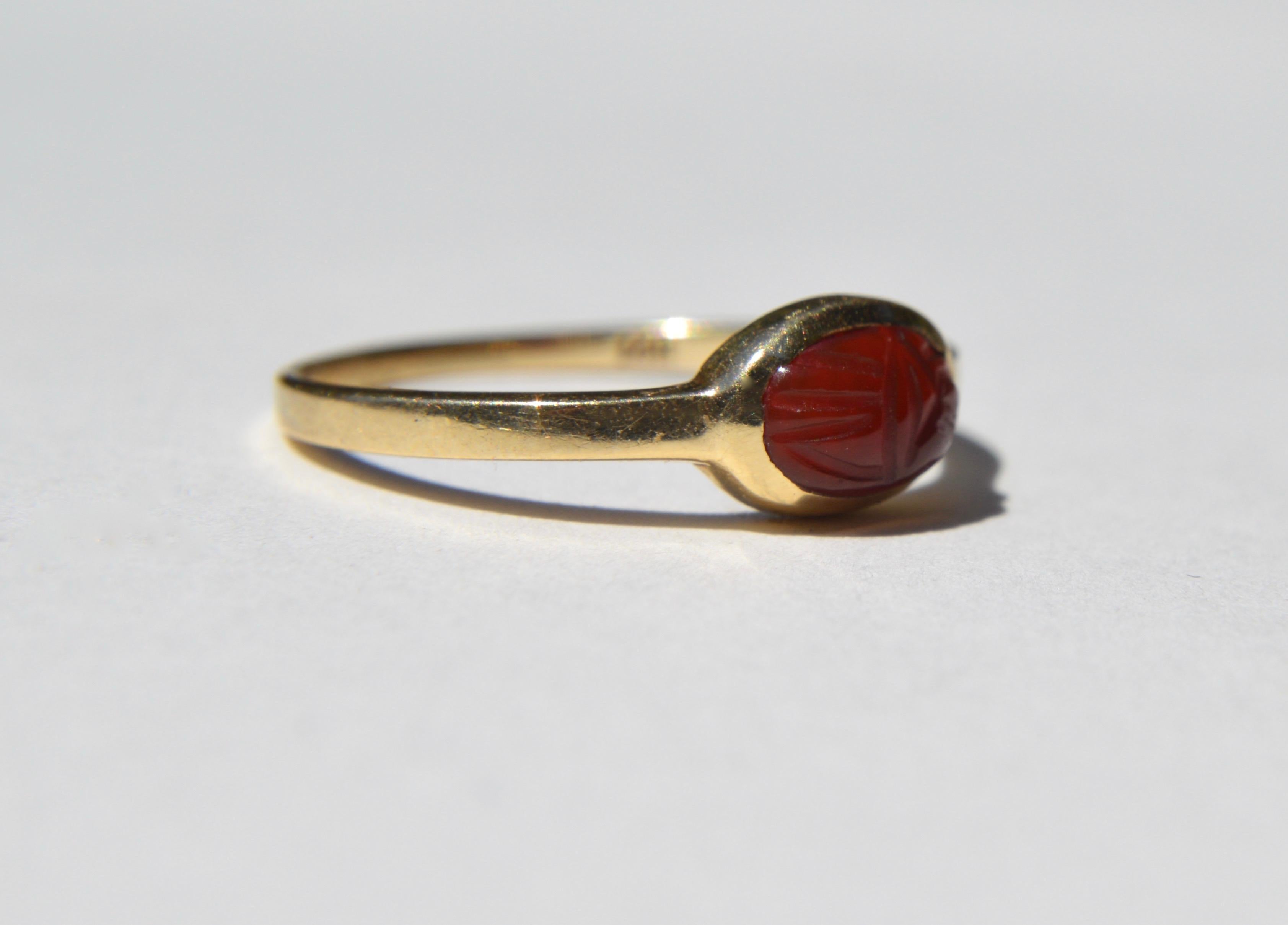 Lovely vintage 14K yellow gold hand carved carnelian Egyptian revival scarab beetle ring. Carnelian cabochon measures 8x5mm, 1.1 carats. In very good condition. Marked as 14K gold. Size 7, can be resized by a jeweler.

Over the history and religious