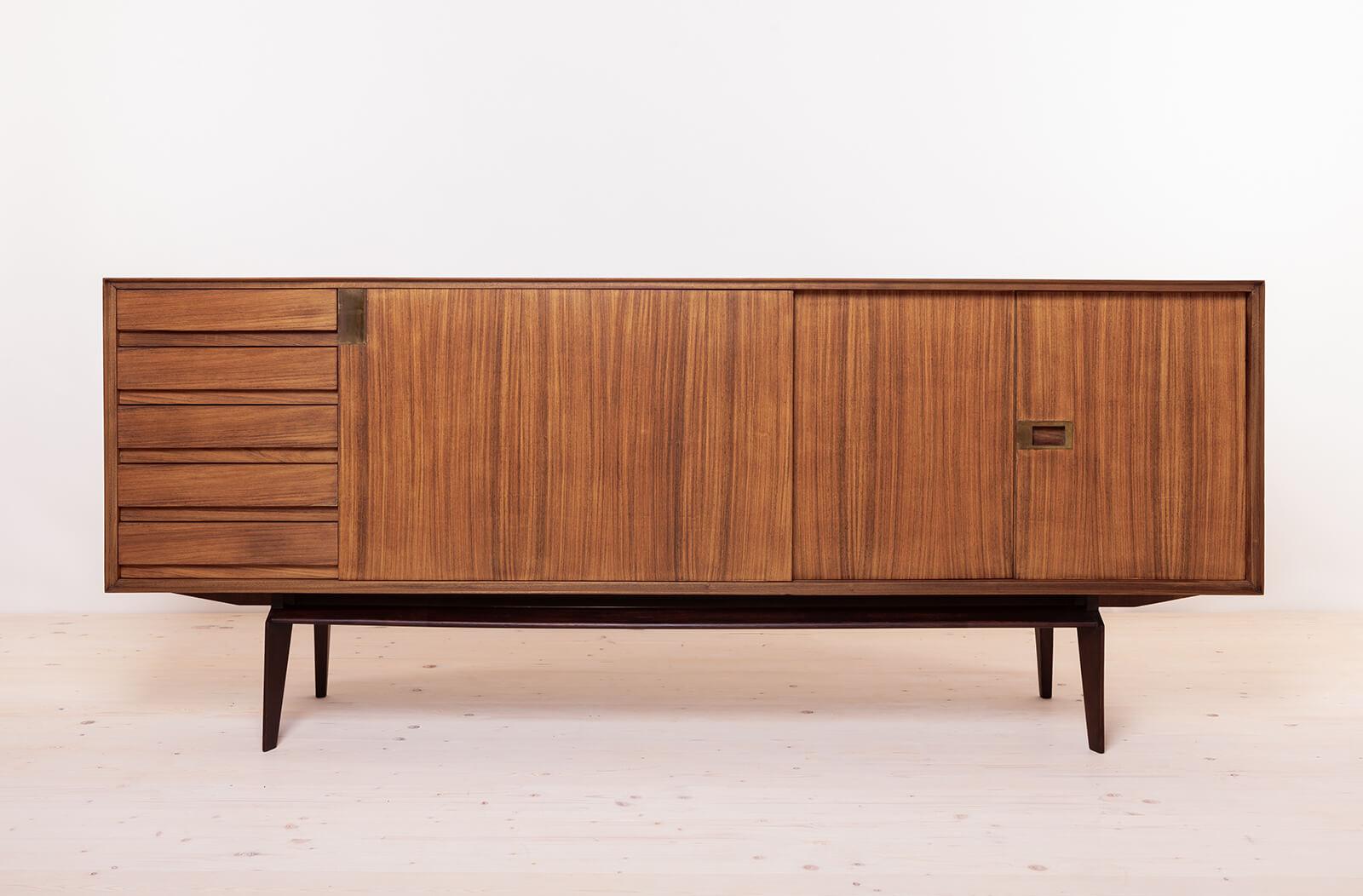 This gorgeous sideboard is a true masterpiece designed by Edmondo Palutari around 1950s for Mobili Dassi Moderni. This extraordinary piece seamlessly blends beautiful Italian design and function, making it a must-have for discerning connoisseurs.
