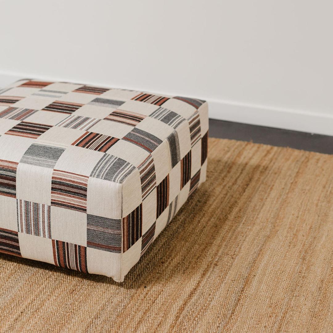 This square ottoman has been reupholstered in a Yarn Collective x Sister wool and linen fabric. Whether you place it in the center of your living room as a stylish coffee table alternative, or use it as a comfortable footrest this piece is as