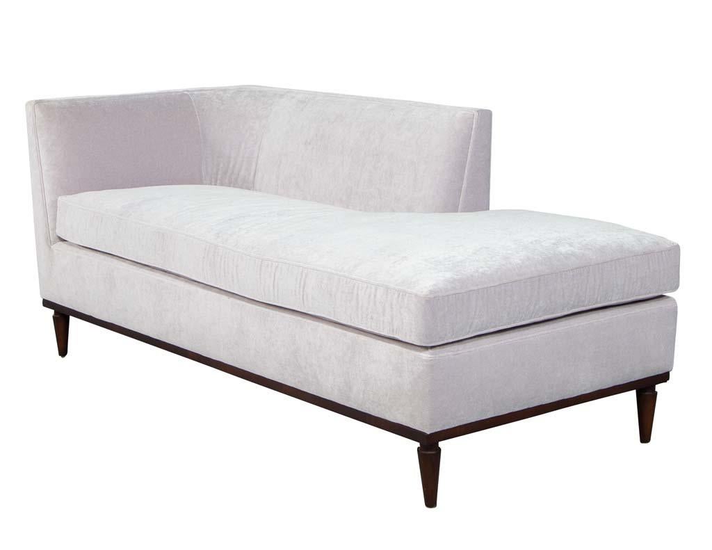 Vintage midcentury style sofa chaise lounge. Upholstered in a velvet material with a pink hue color.