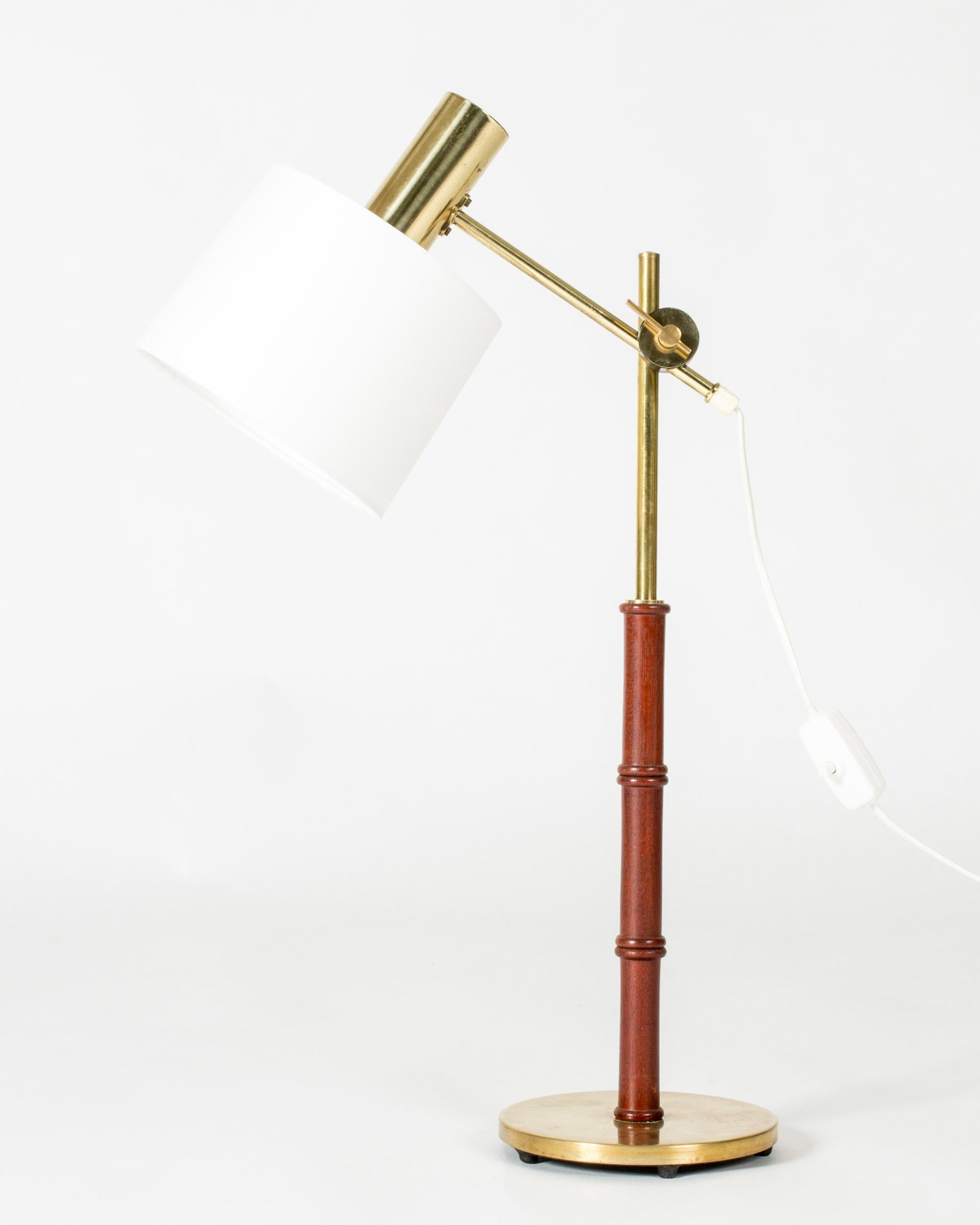 Cool table lamp from Falkenbergs Belysning, made from brass with a mahogany stem. Wood carved into a bamboo-stem form. Adjustable height and angle of the shade.