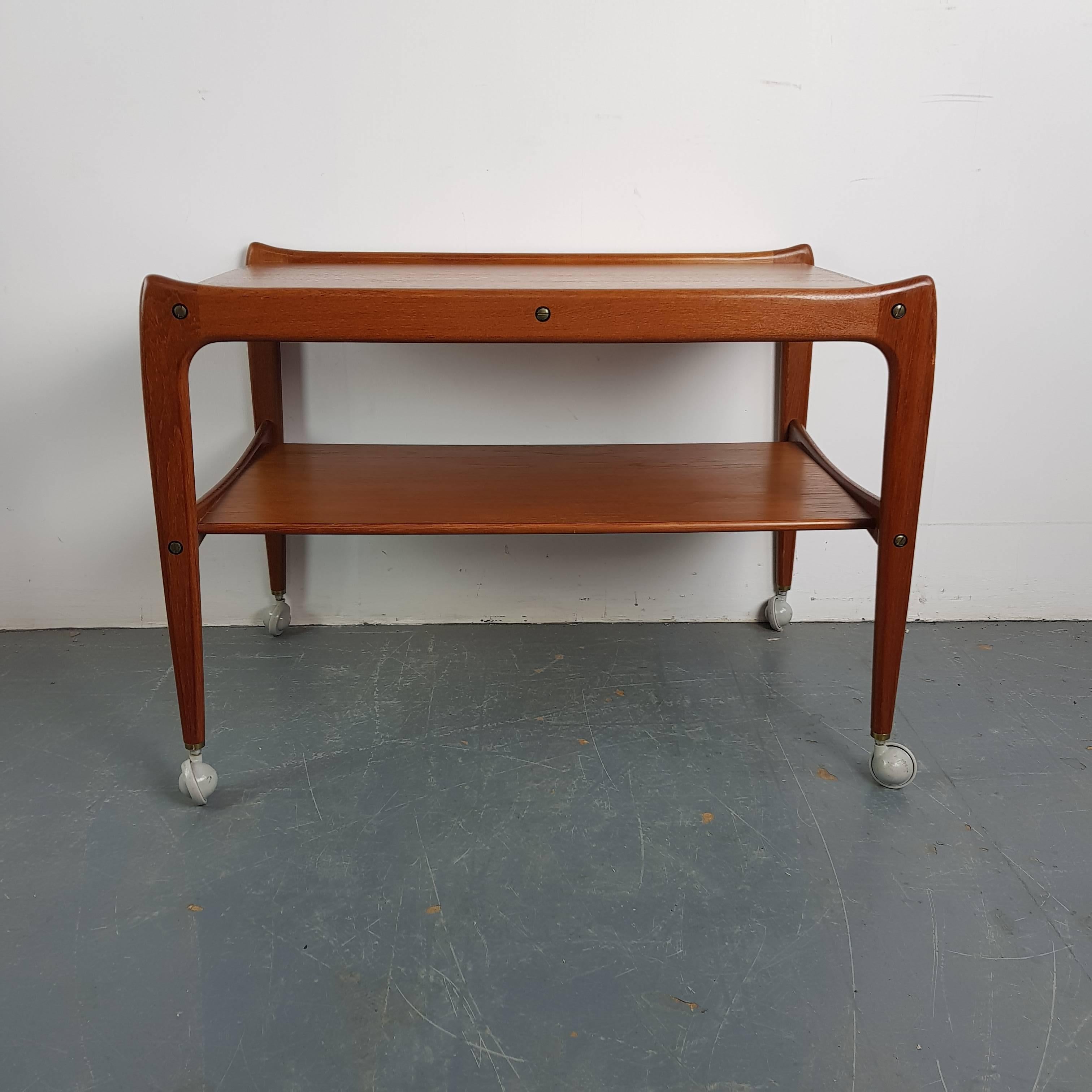Lovely midcentury drinks trolley. Made of teak with two tiers - on castors.

Approximate dimensions:

Height: 57 cm

Width: 78 cm

Depth: 49 cm.

Shelf height 30 cm.