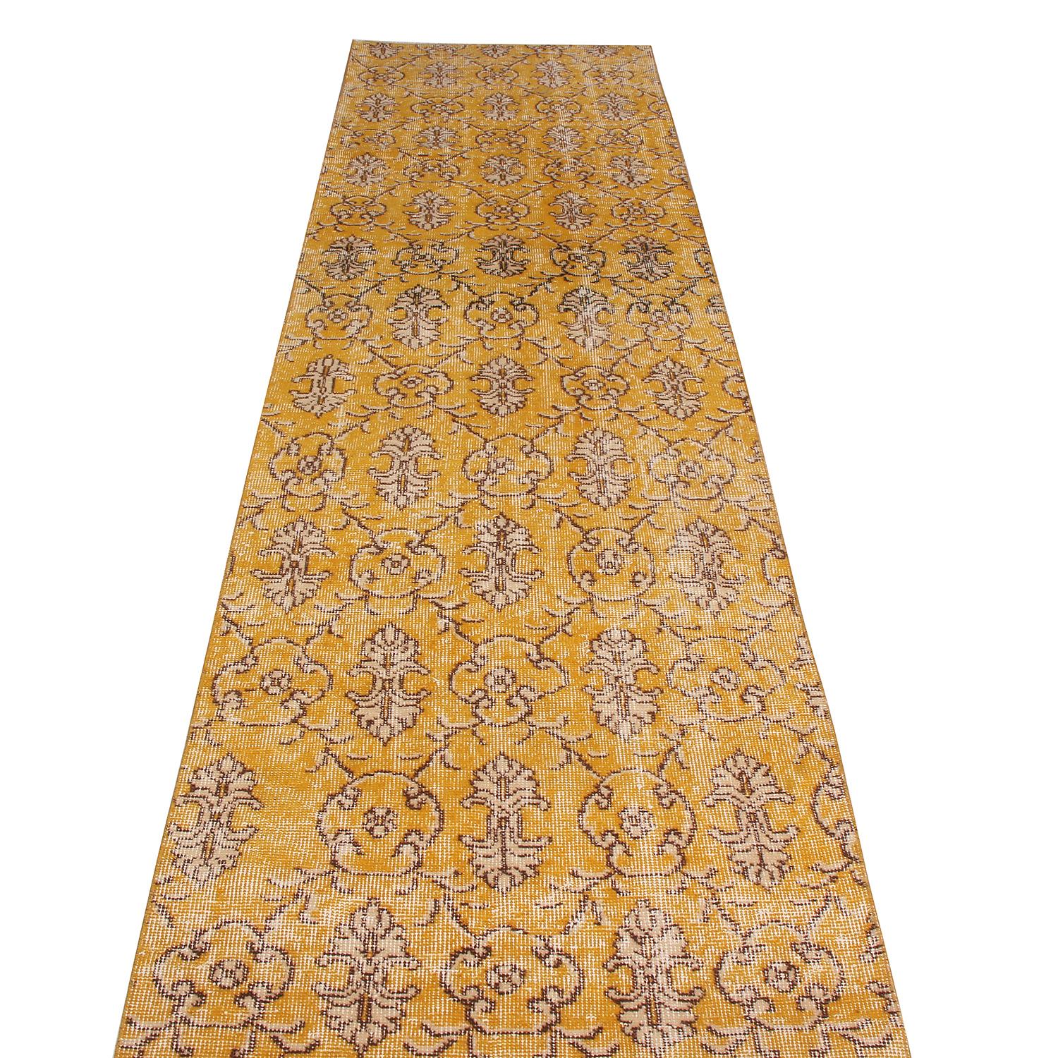 Hand knotted in Turkey originating between 1950-1960, this vintage midcentury wool rug hails from a select series by a very celebrated Turkish designer, enjoying a unique shabby-chic aesthetic. Inspired by Classic oriental traditional styles married