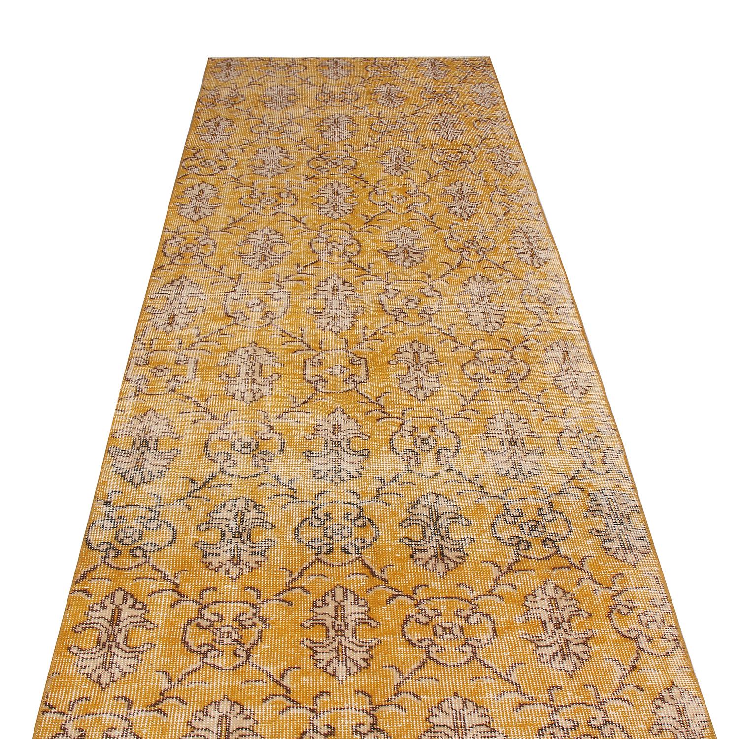 Hand knotted in Turkey originating between 1950-1960, this vintage midcentury wool rug hails from a select series by a very celebrated Turkish designer, enjoying a unique shabby-chic aesthetic. Inspired by Classic oriental traditional styles married
