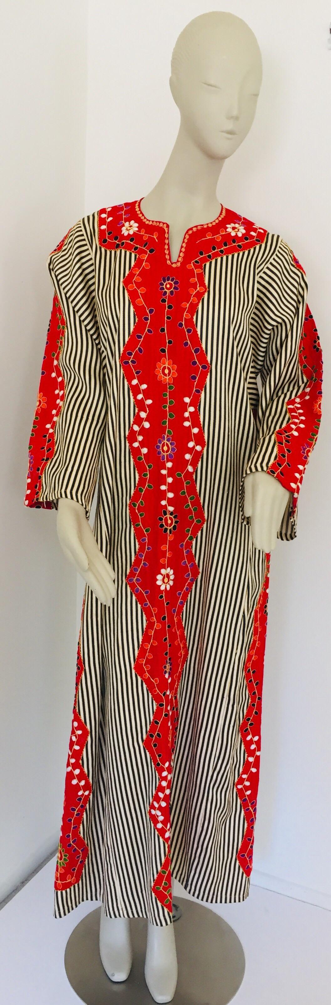 Vintage Middle Eastern kaftan, red embroidered cotton striped maxi dress.
This chic Bohemian maxi dress kaftan is embroidered and embellished by hand. 
It is a slip on light and comfy, cotton fabric.
Vintage exotic 1970s ethnic kaftan. 
Dress