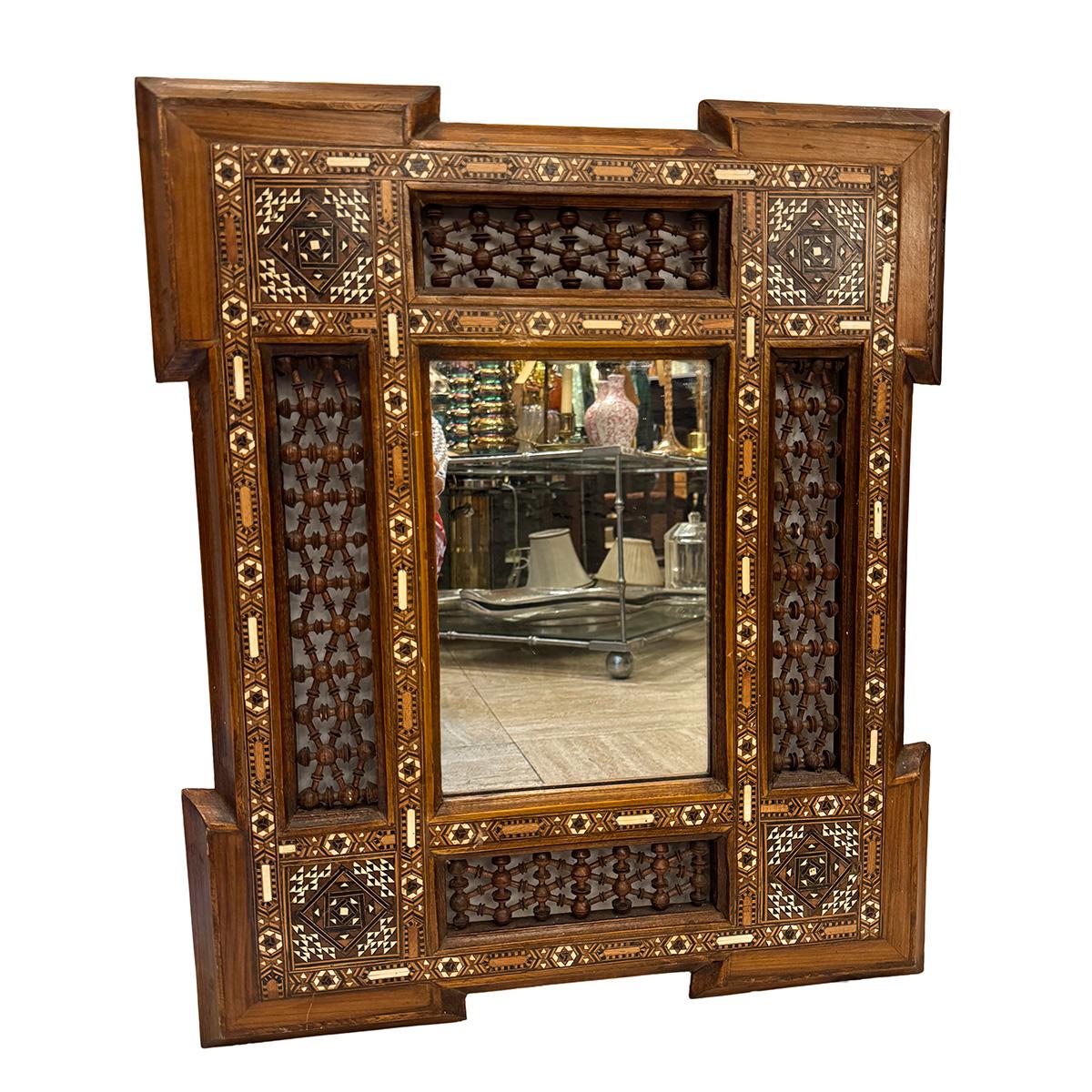 A circa 1950 Persian mirror with marquetry inset in body.

Measurements:
Height: 23.5