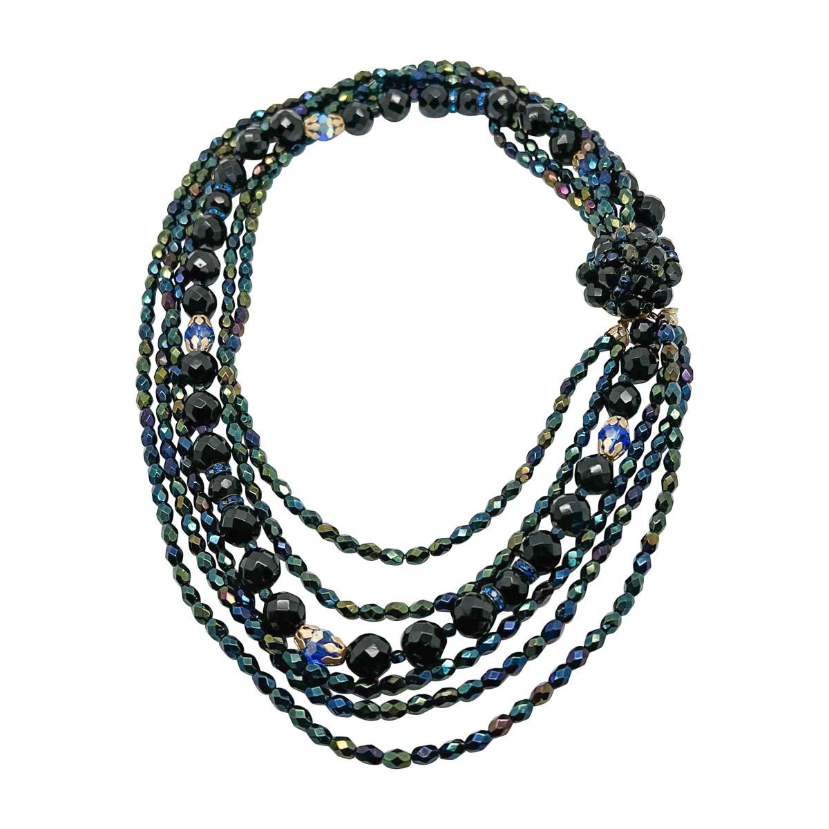 A sumptuous vintage midnight torsade from the 1950s. Comprising a dramatic array of black and midnight blue shades for impact. Intricate detail belies the grand scale. Amplify your style with this stunning work of wearable art.

Vintage Condition: