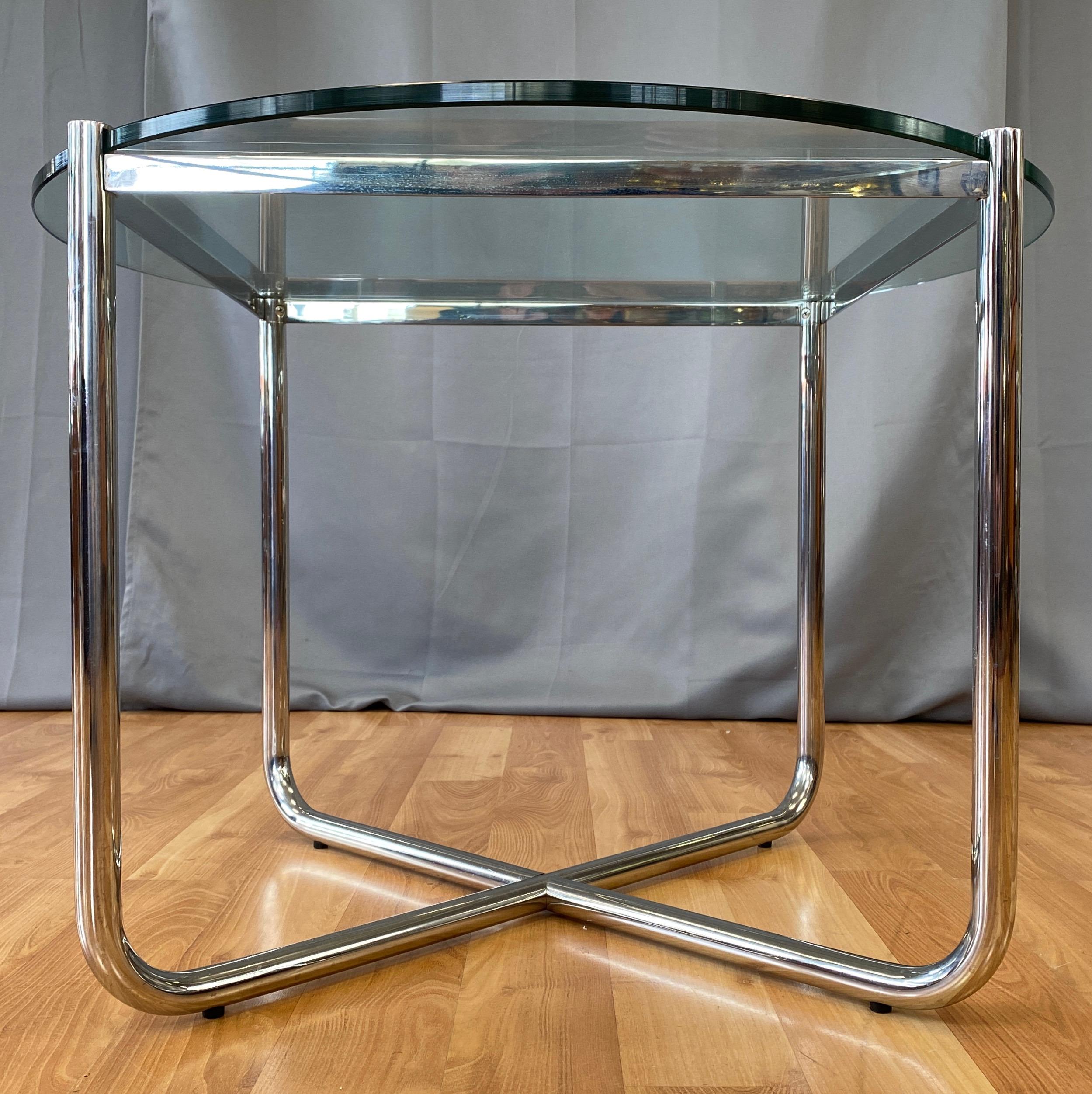 A vintage MR side table designed by Ludwig Mies van der Rohe in 1927, and produced by Knoll International in the 1970s.

Almost entirely seamless mirror-polished tubular and flat bar steel frame with inset .5-inch-thick, 27.5-inch-diameter glass