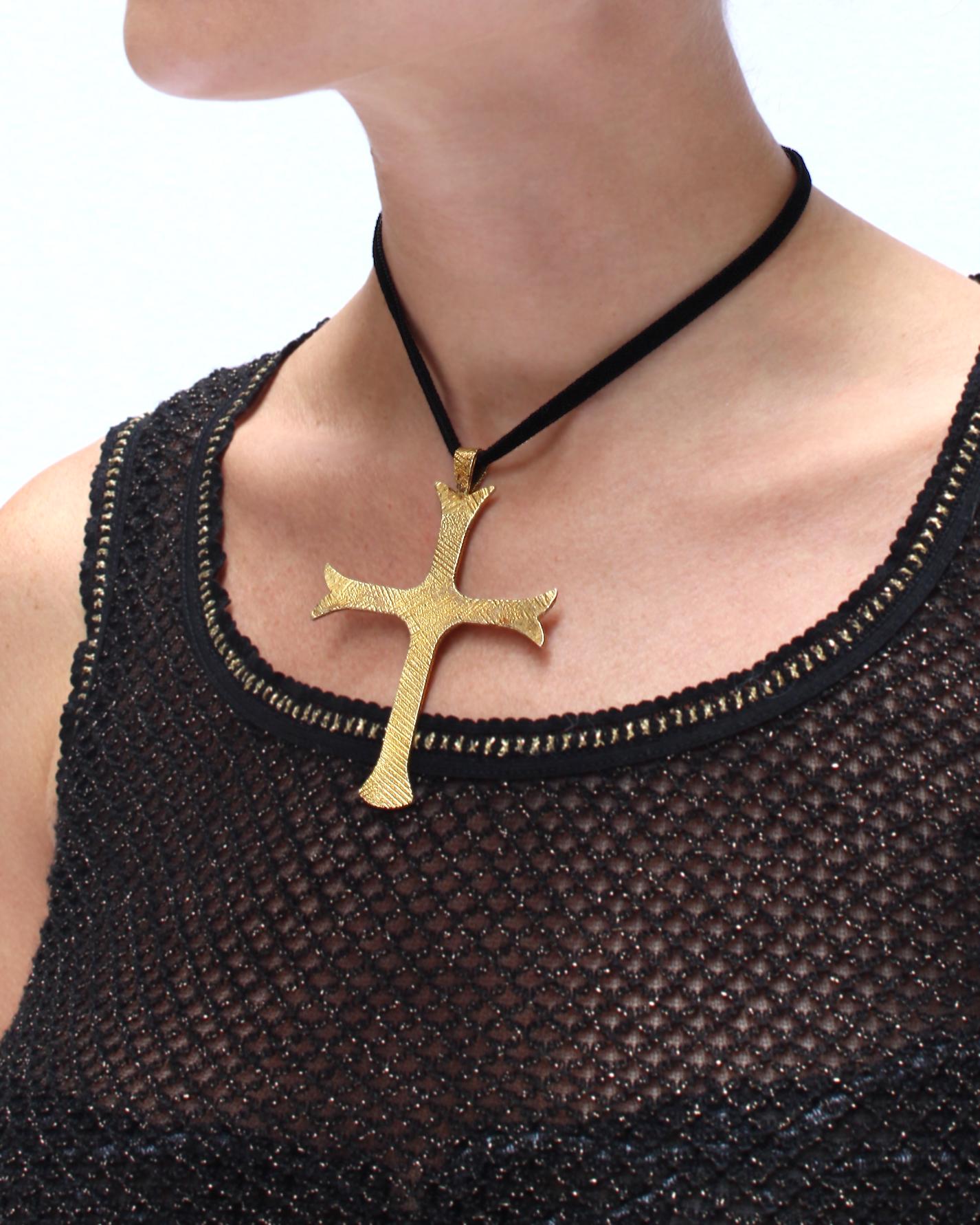 This enormous vintage gold cross is such a statement piece. It was made by Mignon Faget, a New Orleans jeweler known for her hand-crafted quality. The surface is emblazoned with a crosshatch texture, with hand applied patina that accentuates texture