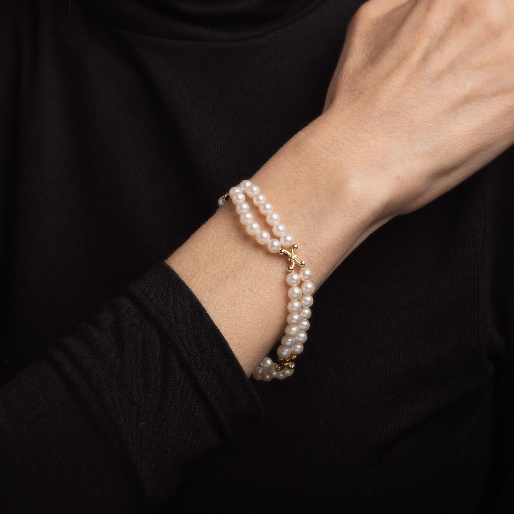 Elegant Mikimoto cultured Akoya pearl bracelet crafted in 14k yellow gold. 

5mm cultured Akoya pearls are strung on two strands. The pearls are lustrous and show rose overtones. 

The double strand bracelet highlights two rows of cultured Akoya