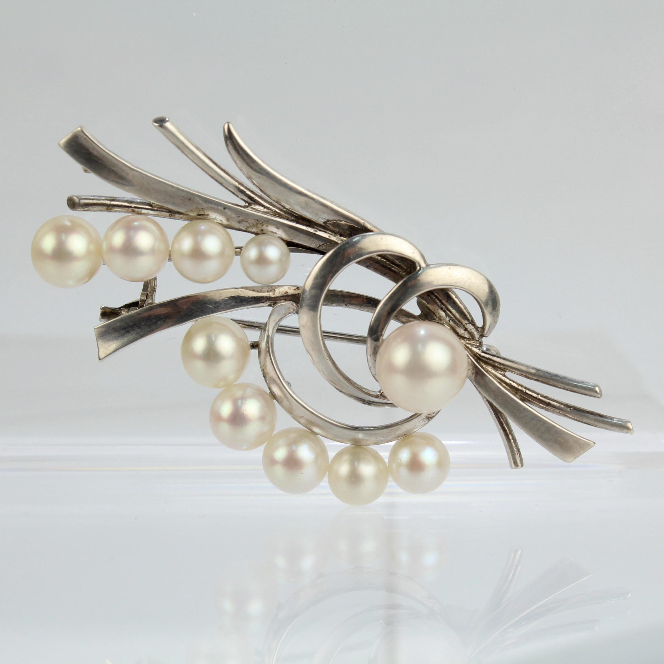 A very fine vintage Mikimoto Akoya cultured pearl and sterling silver brooch or pin.

With graduated round white pearls set on sterling silver bouquet-like stems.

Simply a fine brooch from the legendary Mikimoto!

Date:
20th Century

Overall
