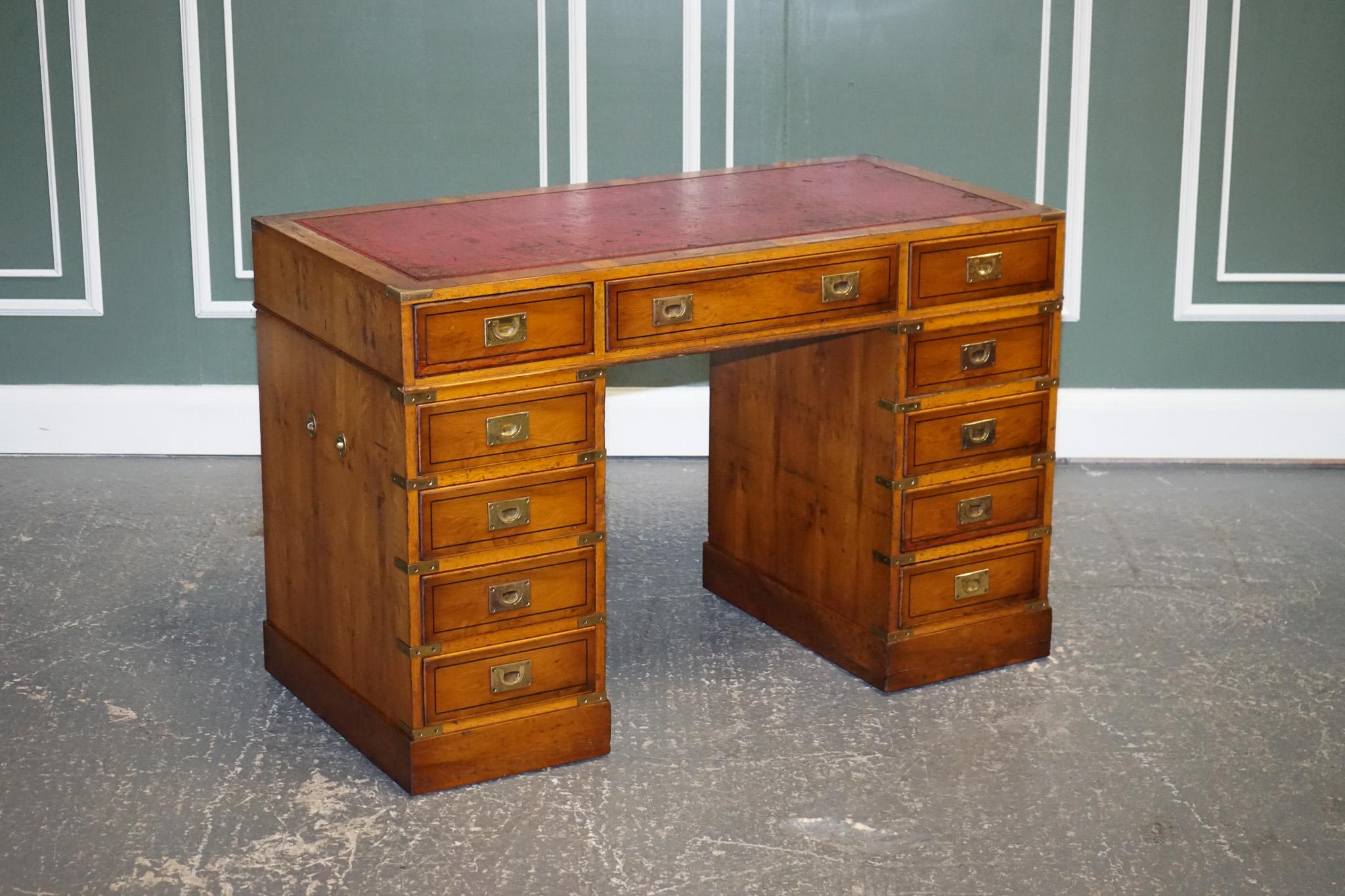 Antiques of London are delighted to offer for sale this vintage military campaign red leather yew wood pedestal desk.

This is a beautiful find, quite rare as it's all drawers, 9 in total. Usually, they have a filing drawer which takes up the