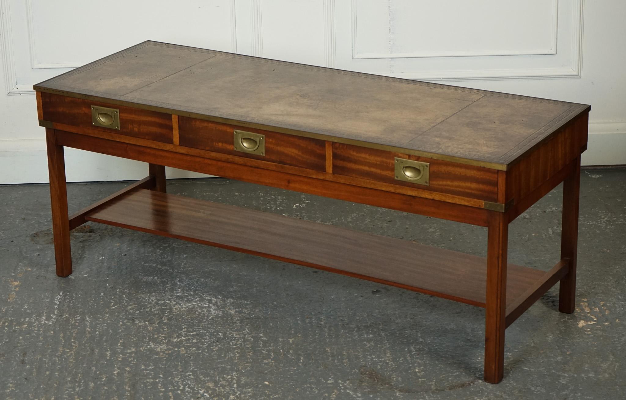 
We are delighted to offer for sale this Vintage Military Campaign Style Coffee Table With Brown Aged Leather.

 Three drawers is a stunning and unique piece of furniture. It embodies the charm and character of the military campaign style,