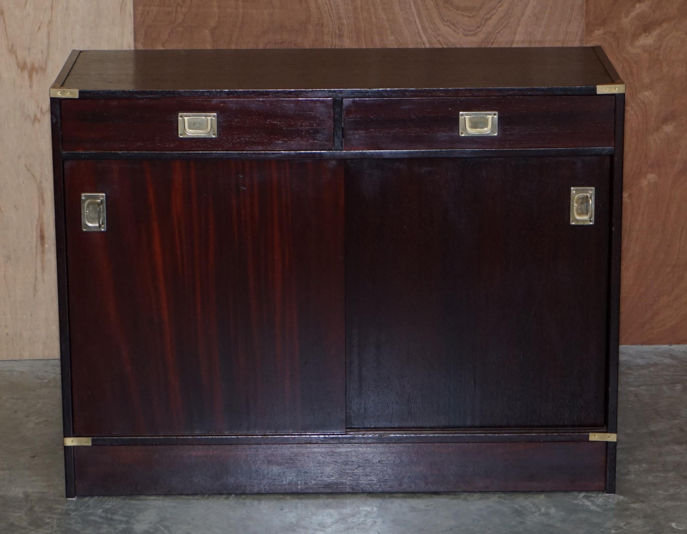 We are delighted to offer this vintage Military Campaign mahogany sideboard with brass fittings.

A good looking well made and decorative piece. Military campaign furniture never goes out of style. This has sliding doors which reveal a nice sized