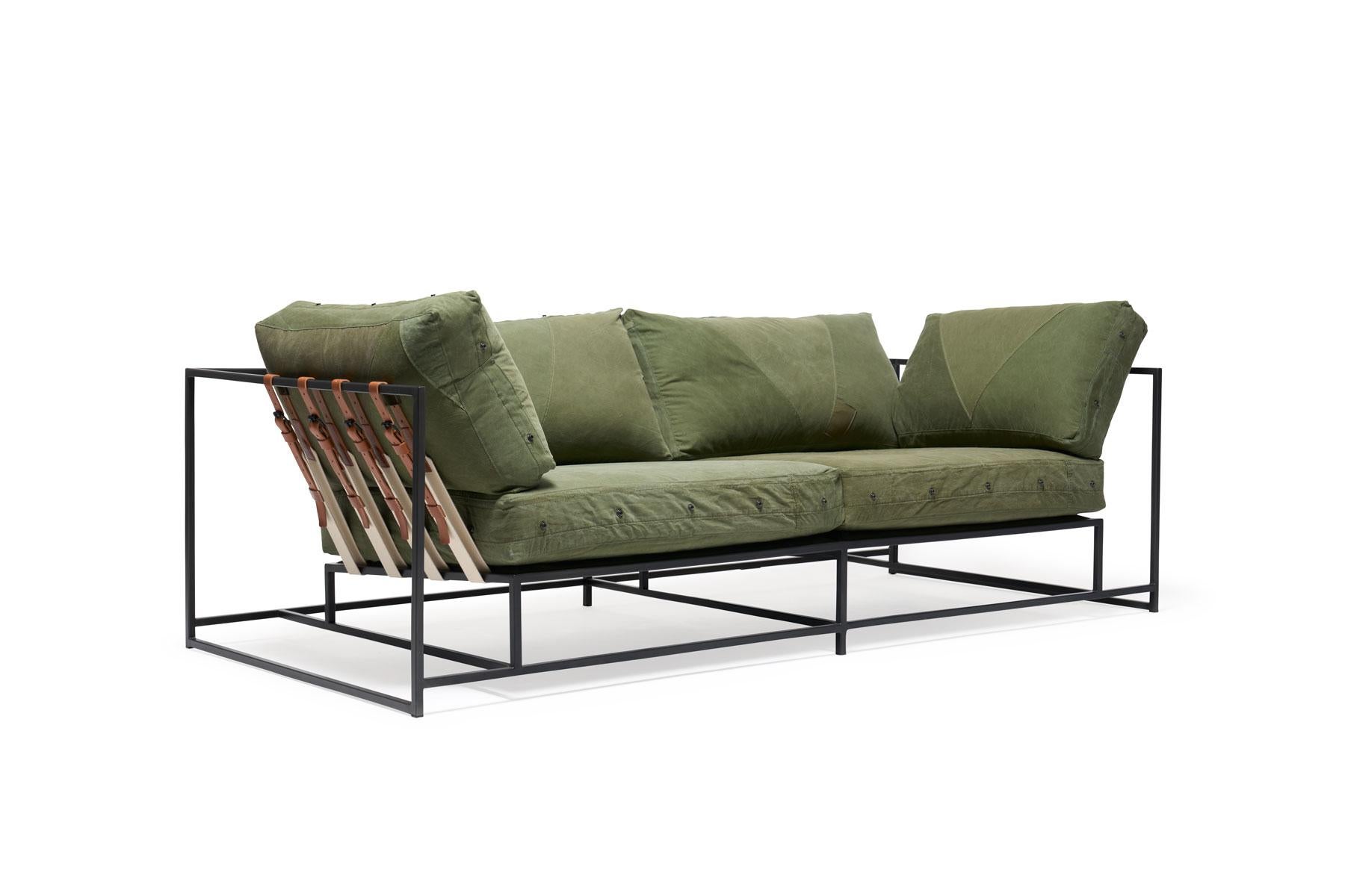 The Inheritance two-seat sofa by Stephen Kenn is as comfortable as it is unique. The design features an exposed construction composed of three elements - a steel frame, plush upholstery, and supportive belts. The deep seating area is perfect for a
