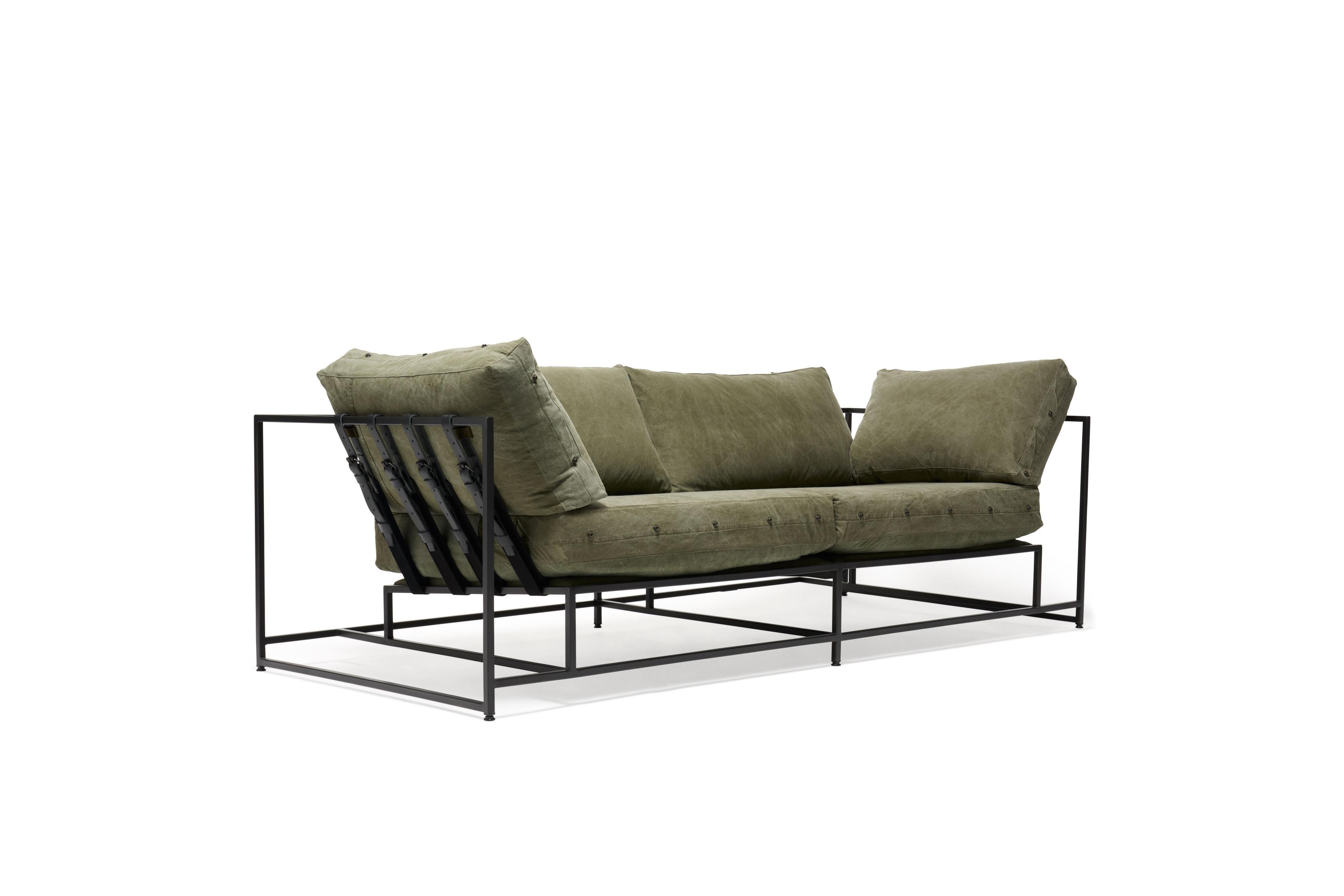 The Inheritance Two Seat Sofa by Stephen Kenn is as comfortable as it is unique. The design features an exposed construction composed of three elements - a steel frame, plush upholstery, and supportive belts. The deep seating area is perfect for a