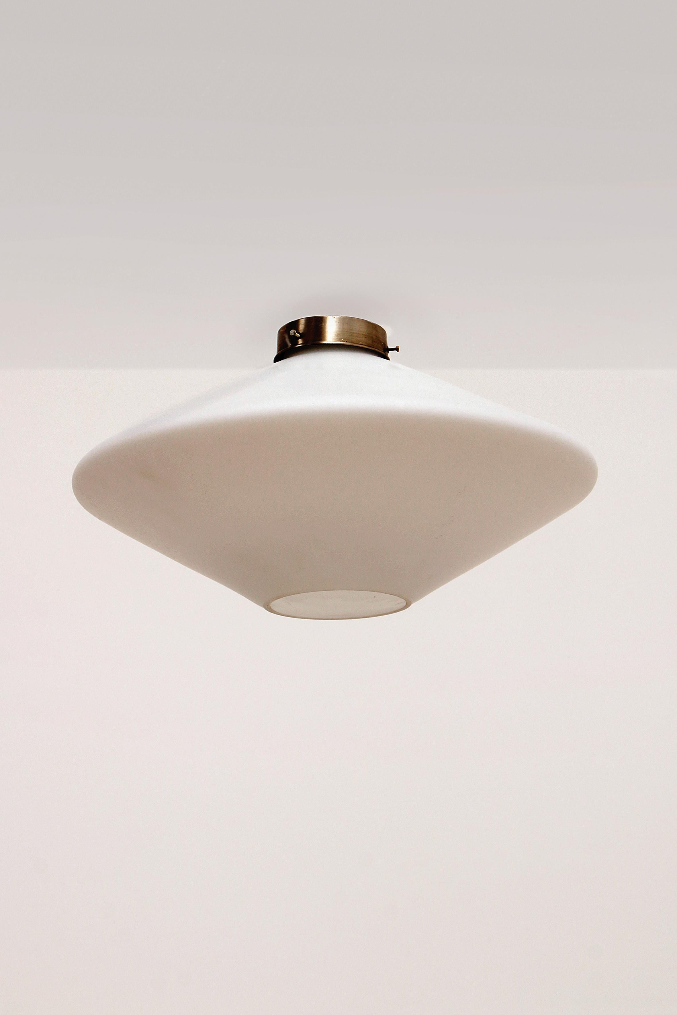 Vintage ceiling lamp from the late fifties early sixties. Specially designed white milk glass UFO hanging on a chrome-colored metal hood. The condition is good considering the age.

Sustainable: environmentally conscious By supplementing your