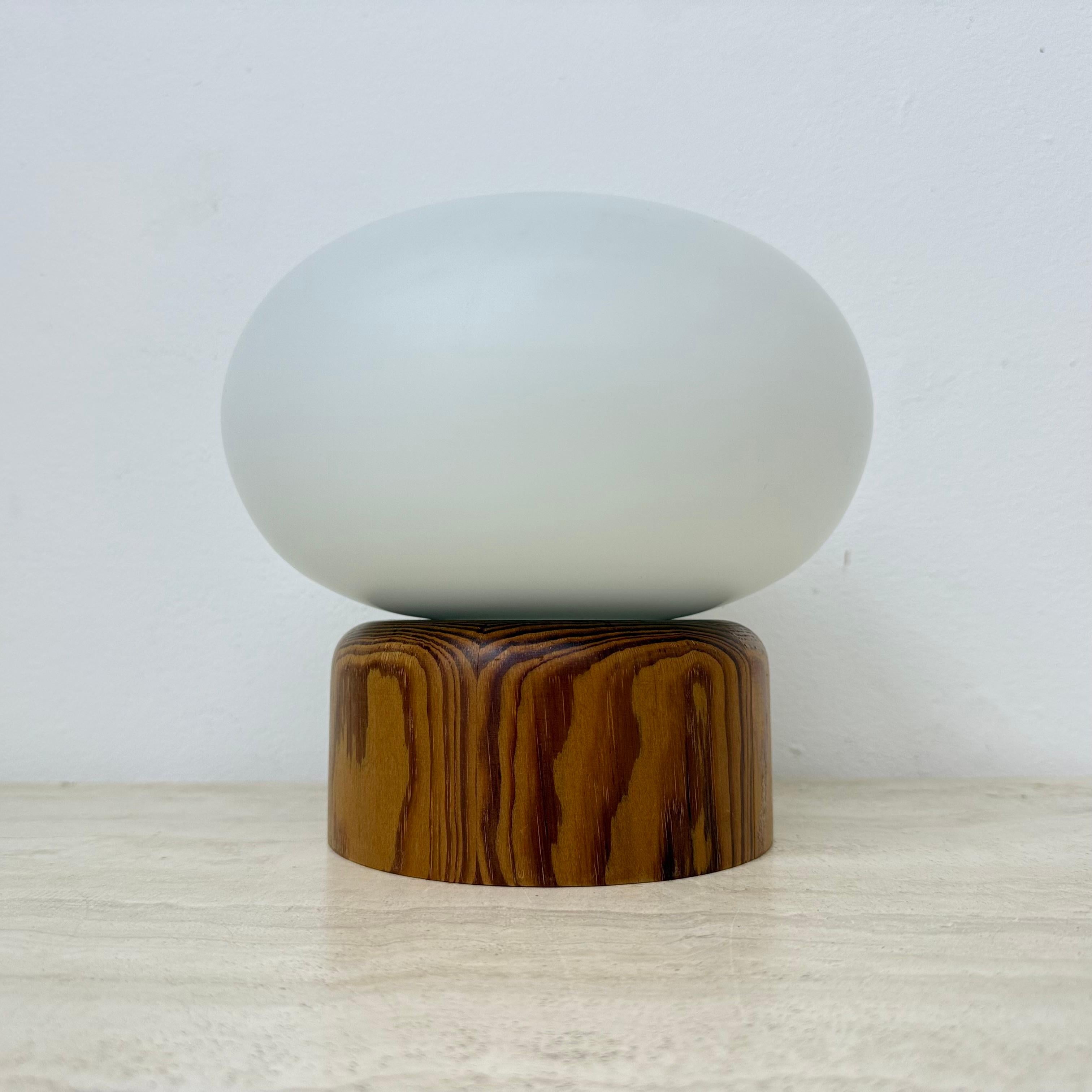 Vintage milk glass table lamp with wooden base by Bestform Freudenberg , 1970

Dimension: 19 cm Height , 20cm Diameter
Condition: Good
Period: 1970s
Material: Glass , wood