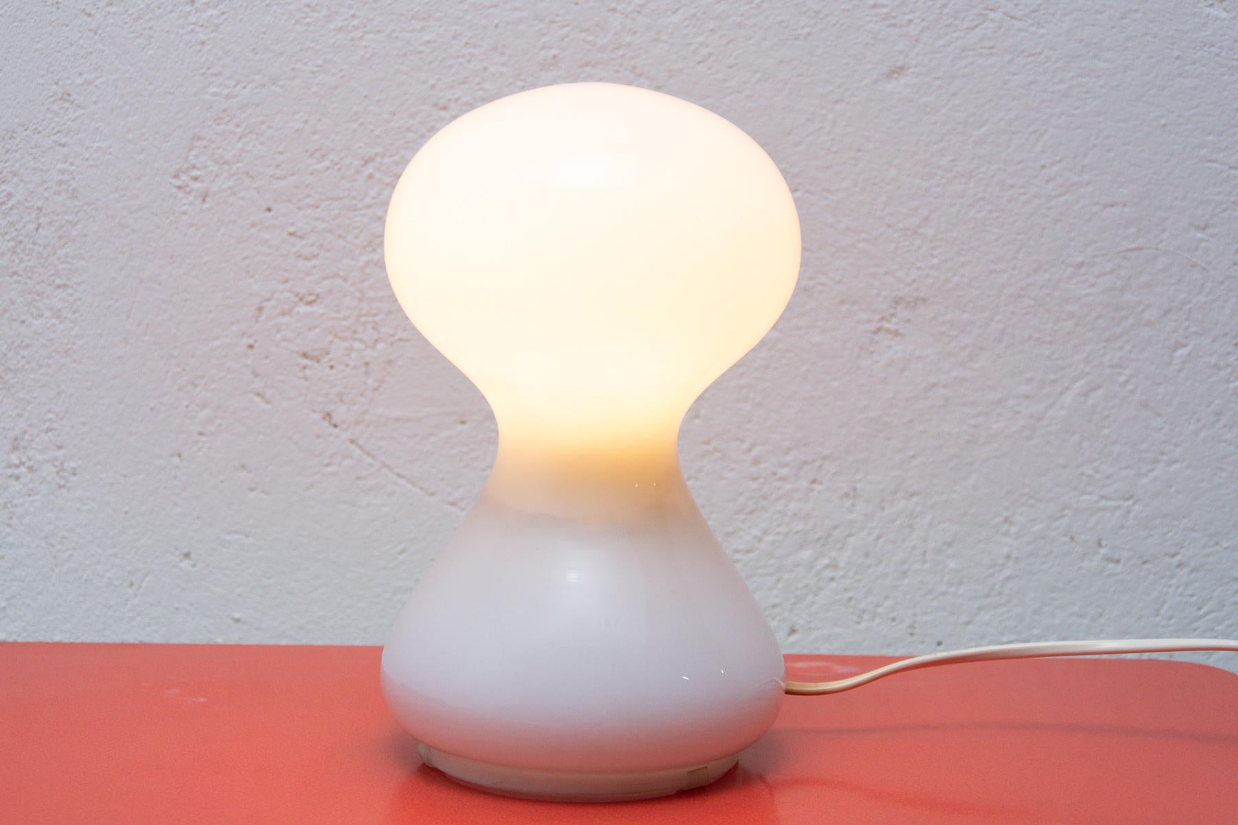 Glass lamp made of white milk glass, it was designed by Ivan Jakeš in the early 1970s and was produced by OS Valašské Mezirící. The lamp has a very pleasant dim light and can also be used as an interesting decoration. The lamp is in excellent
