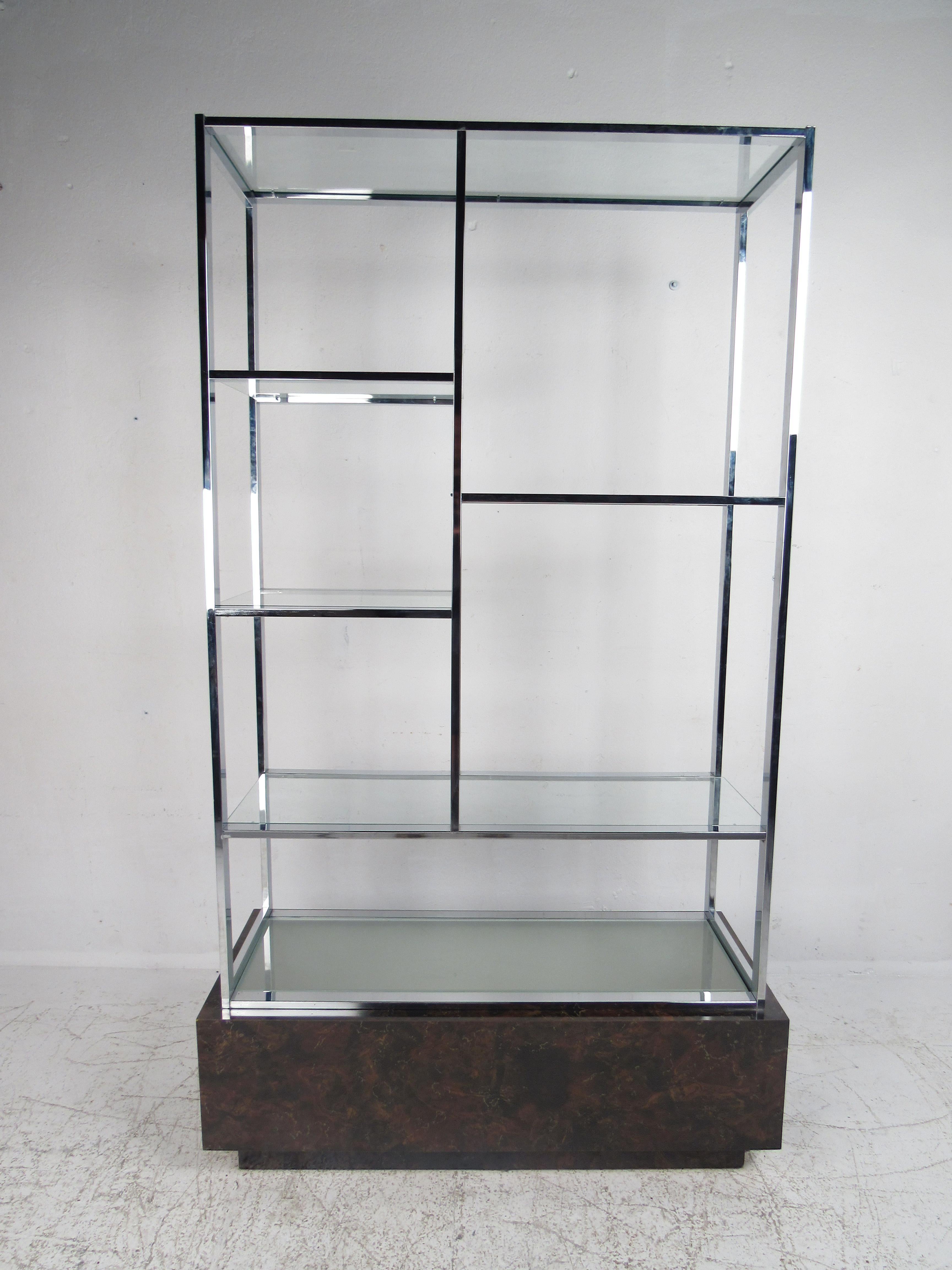 A stunning Mid-Century Modern étagère features a light-up burl base topped with a cloudy glass shelf. This impressive shelving unit has four glass shelves in the middle, perfect for displaying items. The elegant chrome frame with a cubed burl base