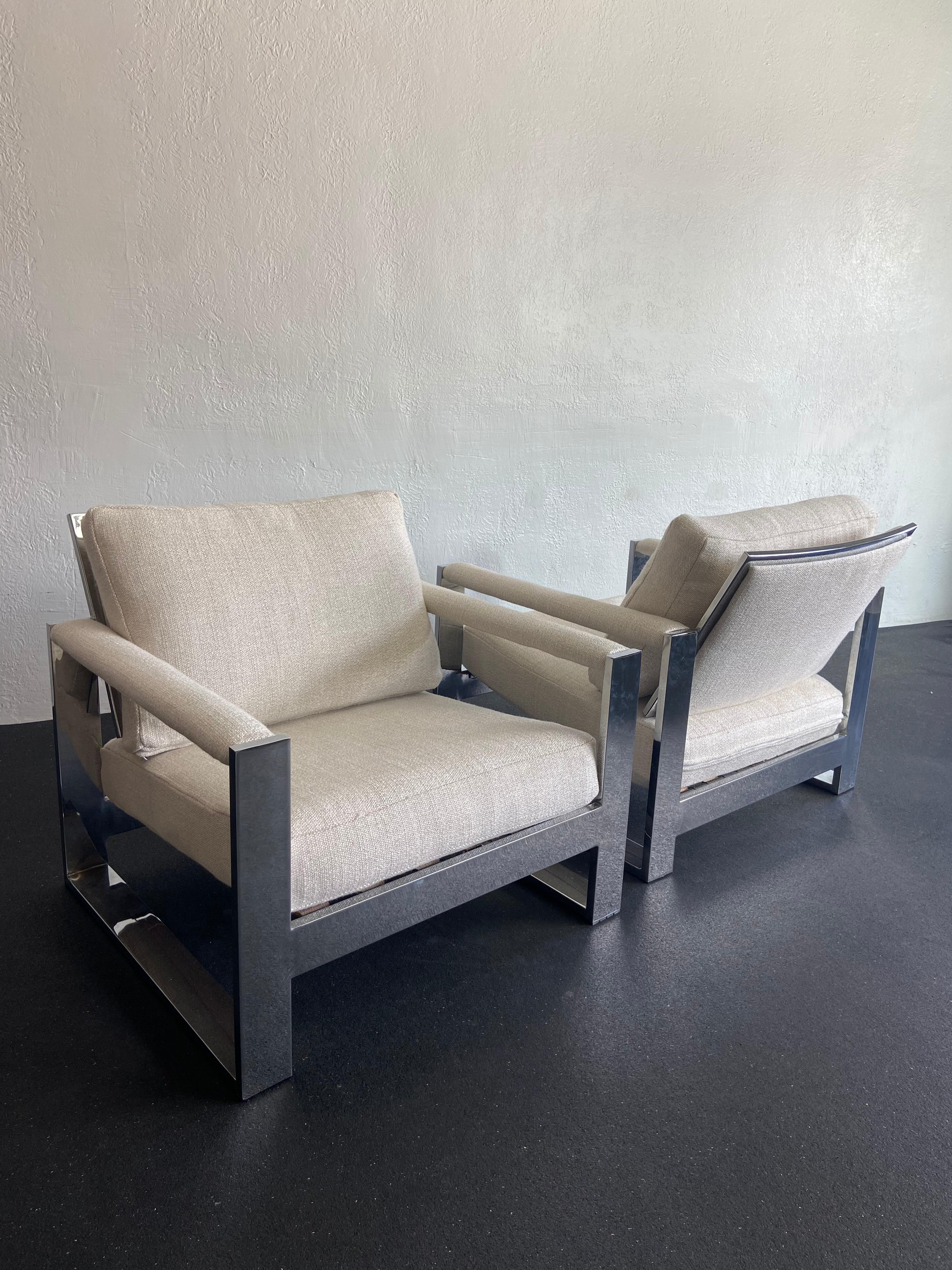 Pair of Milo Baughman for Thayer Coggin chrome lounge chairs. Oversized frames seat very comfortably. Chairs have been reupholstered in a heavy weight textured oat. Chairs have not retained the original manufacturer labels and thus are