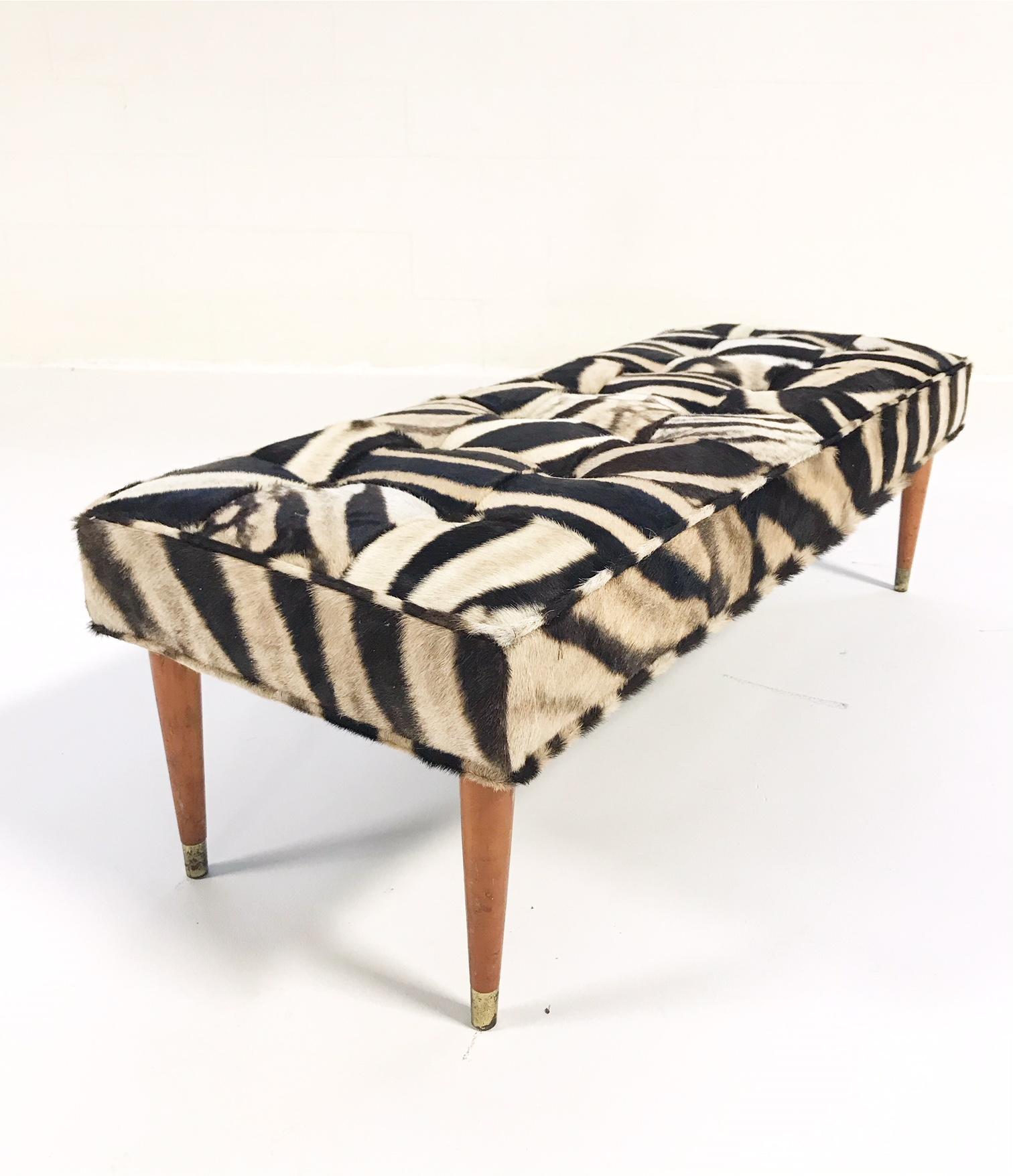 We keep picturing this gorgeous one-of-a-kind bench at the end of a beautiful bed or down a handsome hallway. Our designers chose to do a patchwork zebra hide as an extra design detail, complementing the simple wood and brass straight