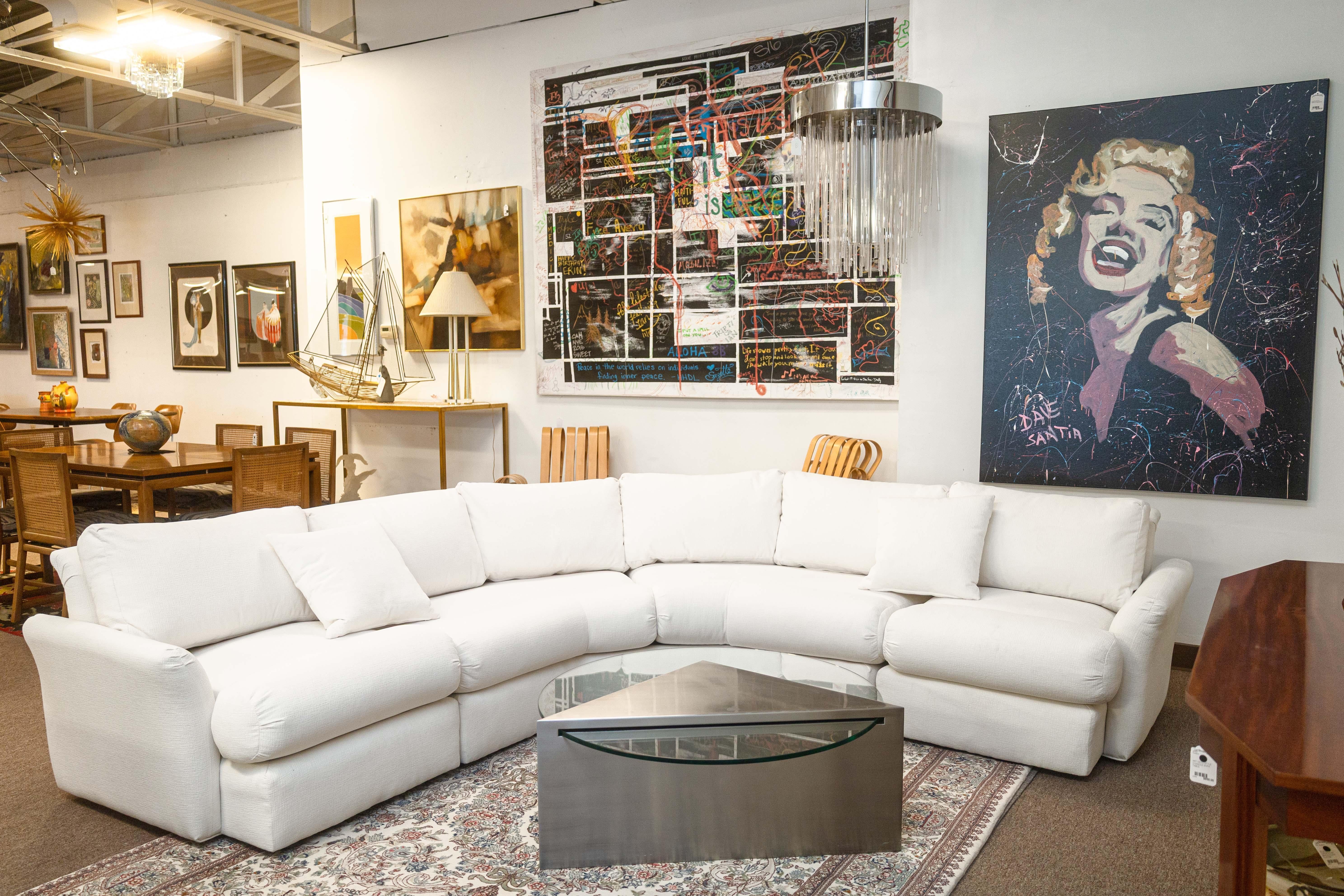 A vintage Milo Baughman 3 piece sectional sofa. This is a classic Baughman style sofa featuring a stunning, chic white textures fabric upholstery. This curved sectional consists of three separating pieces; a curved corner piece, and two end pieces