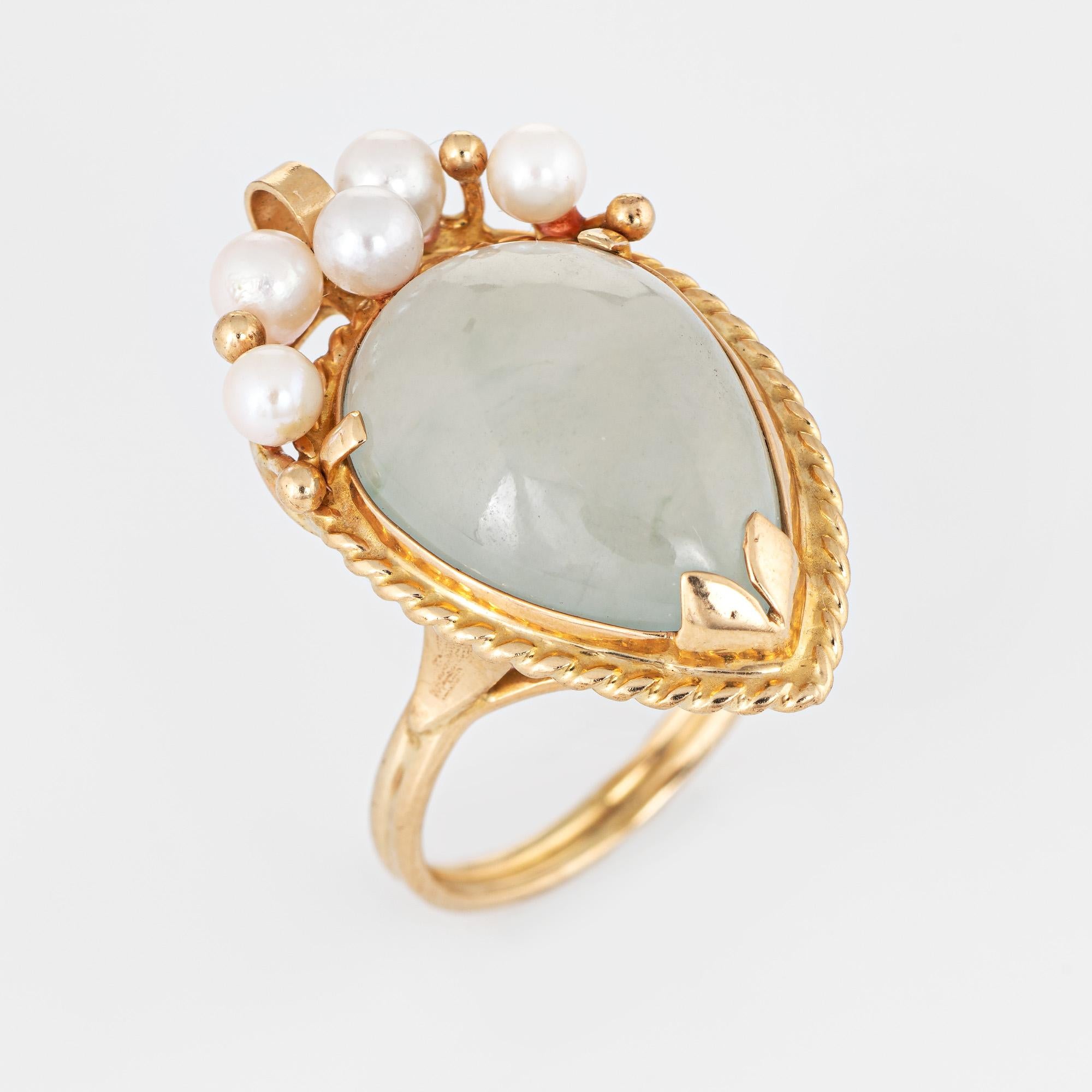 Stylish vintage Ming's jade & cultured pearl cocktail ring crafted in 14 karat yellow gold. 

Cabochon cut jade measures 16.5mm x 12.5mm (estimated at 15 carats) accented with five 3mm to 4mm cultured pearls. The jade is in excellent condition and
