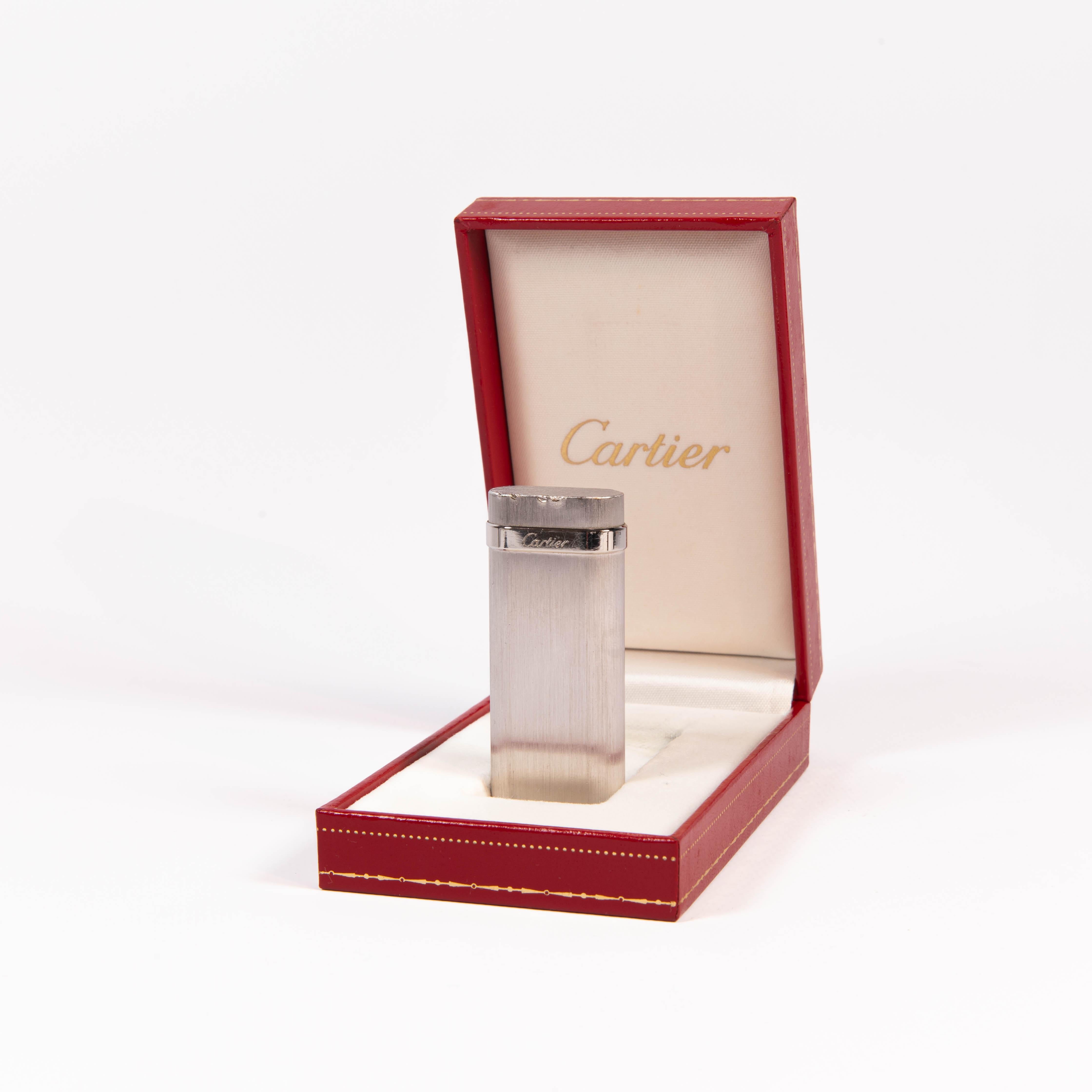 This small silver-plated Cartier Les must lighter is indeed eye candy. Fully functional, sparks excellent, and lights every time. The lighter is in great condition. Its brushed silver plated surface only has minor wear from all those years. There