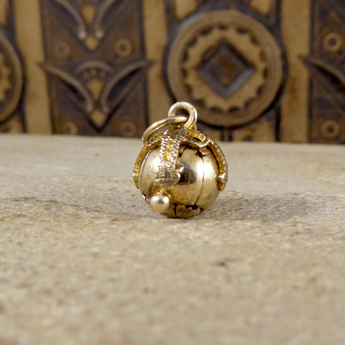 This vintage mini folding orb pendant appears initially to simply be a Gold sphere, however the four hinged arms open to show a cross shape formed by six pyramids. On these, are a variety of symbols including the tools of stonemasons to represent