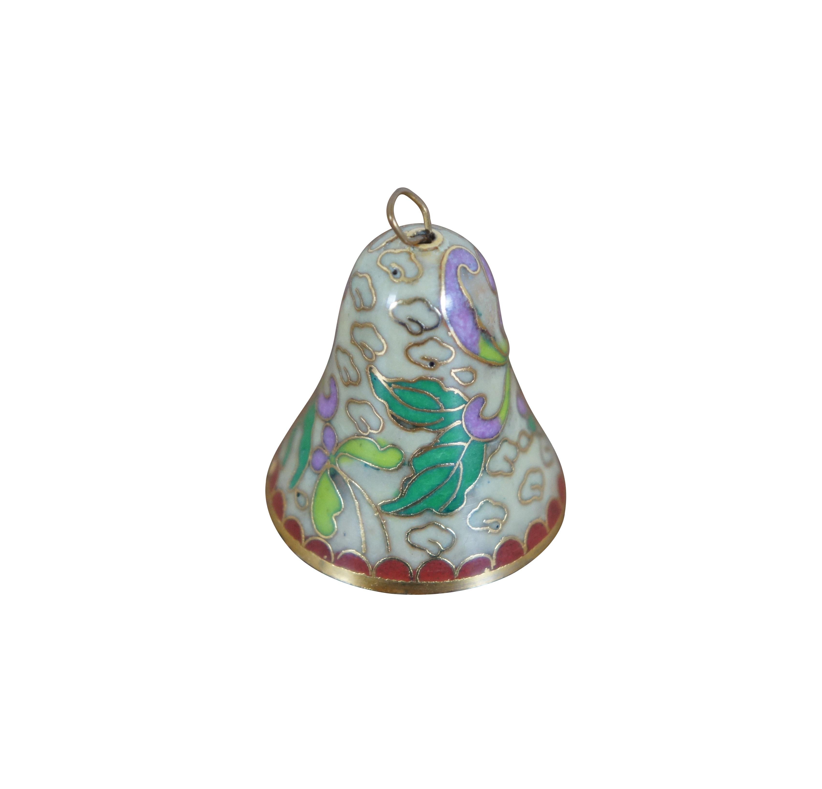 Vintage Chinese cloisonne enamel on brass bell featuring a design of swirling purple and green flowers on a beige backdrop of clouds and red scalloped trim. 

Dimensions:
1.125