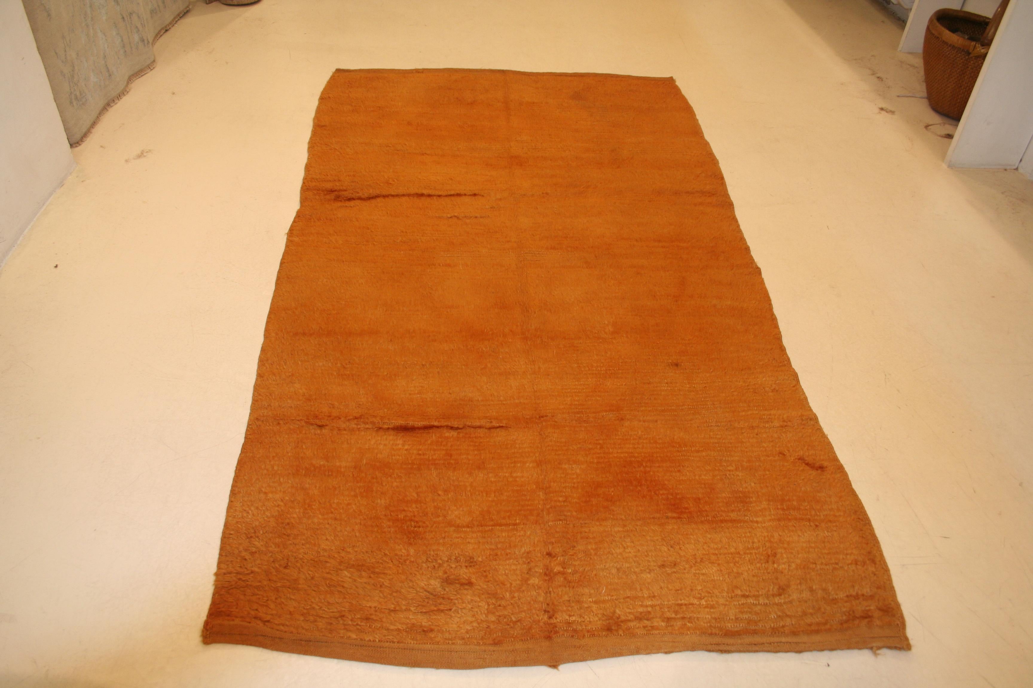 A rare and relatively early example of central Anatolian Tulu rug, distinguished by a completely open field in a very unusual shade of copper. Tulus of this type are among the earliest extant and are distinguished by a larger format. These were used