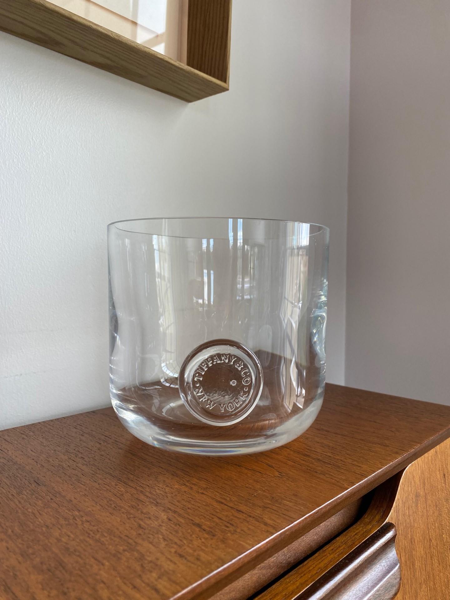 Beautiful and dazzling crystal ice bucket.  This beautiful full lead crystal piece from Tiffany sparkles and catches the eye.  Incredibly minimal footprint that will work with any décor, this piece becomes iconic with the Tiffany & Co glass seal and