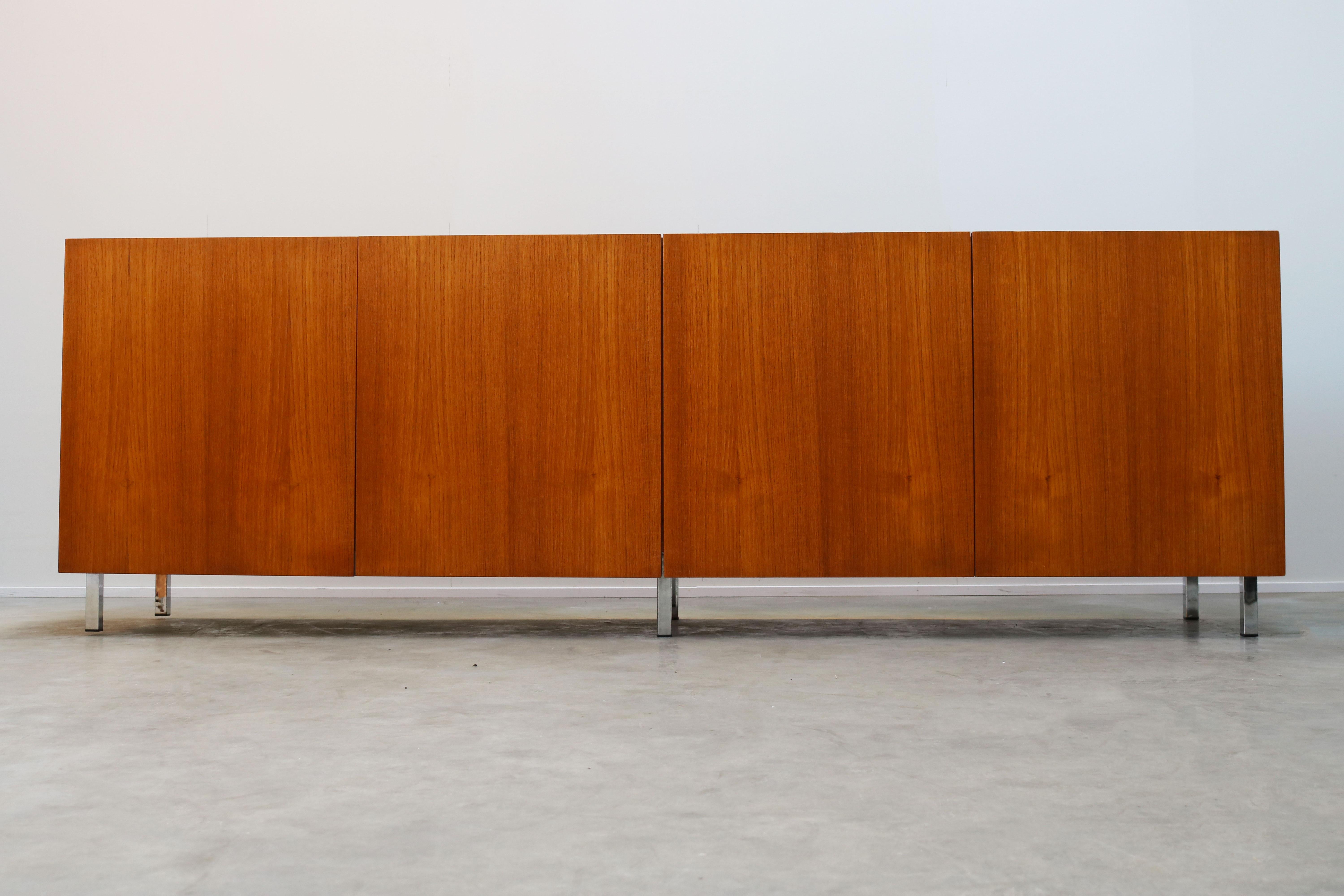 Minimalist Danish sideboard / credenza in teak with chrome legs made in the 1950s. Wonderful clean modern design. The sideboard has 2 shelves and plenty of storage space. Sideboard is in great vintage condition with minor traces of use.